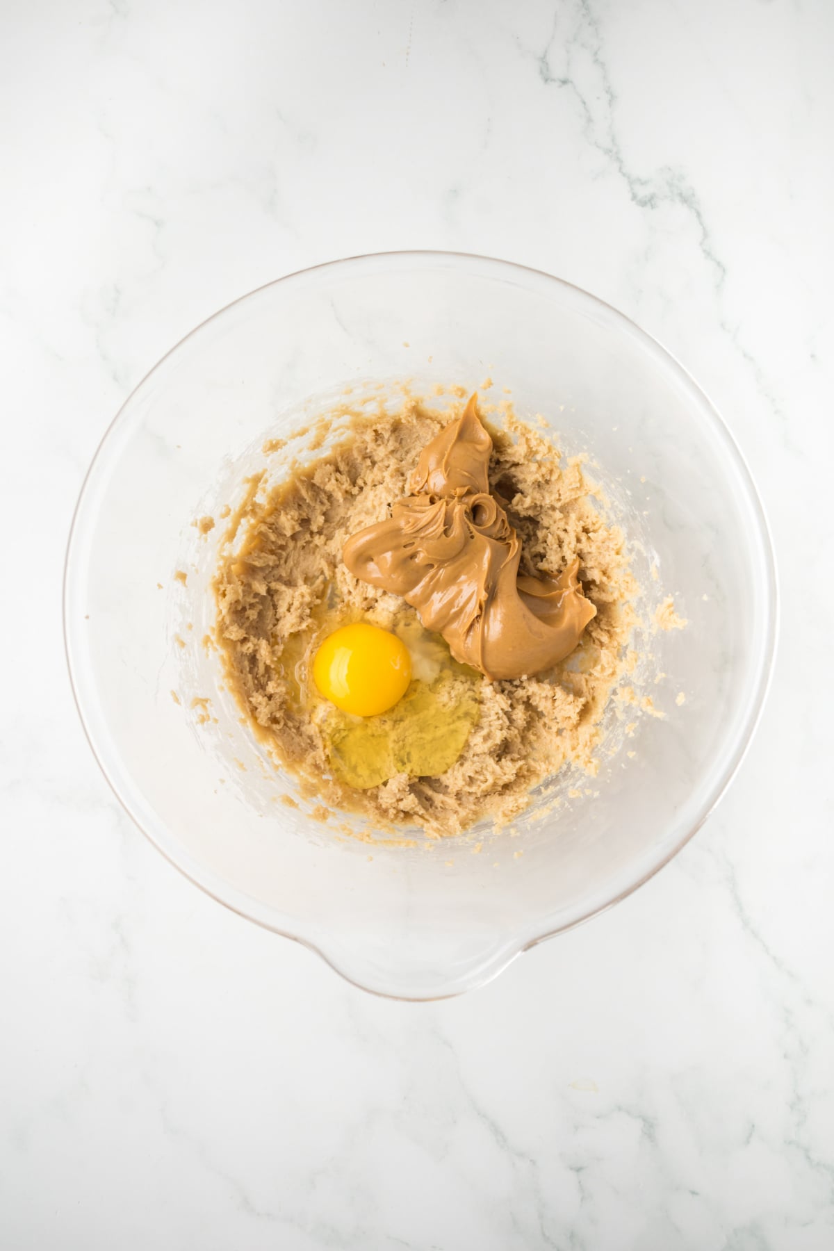 Peanut butter, brown sugar, butter, and egg mixed together in a large bowl.