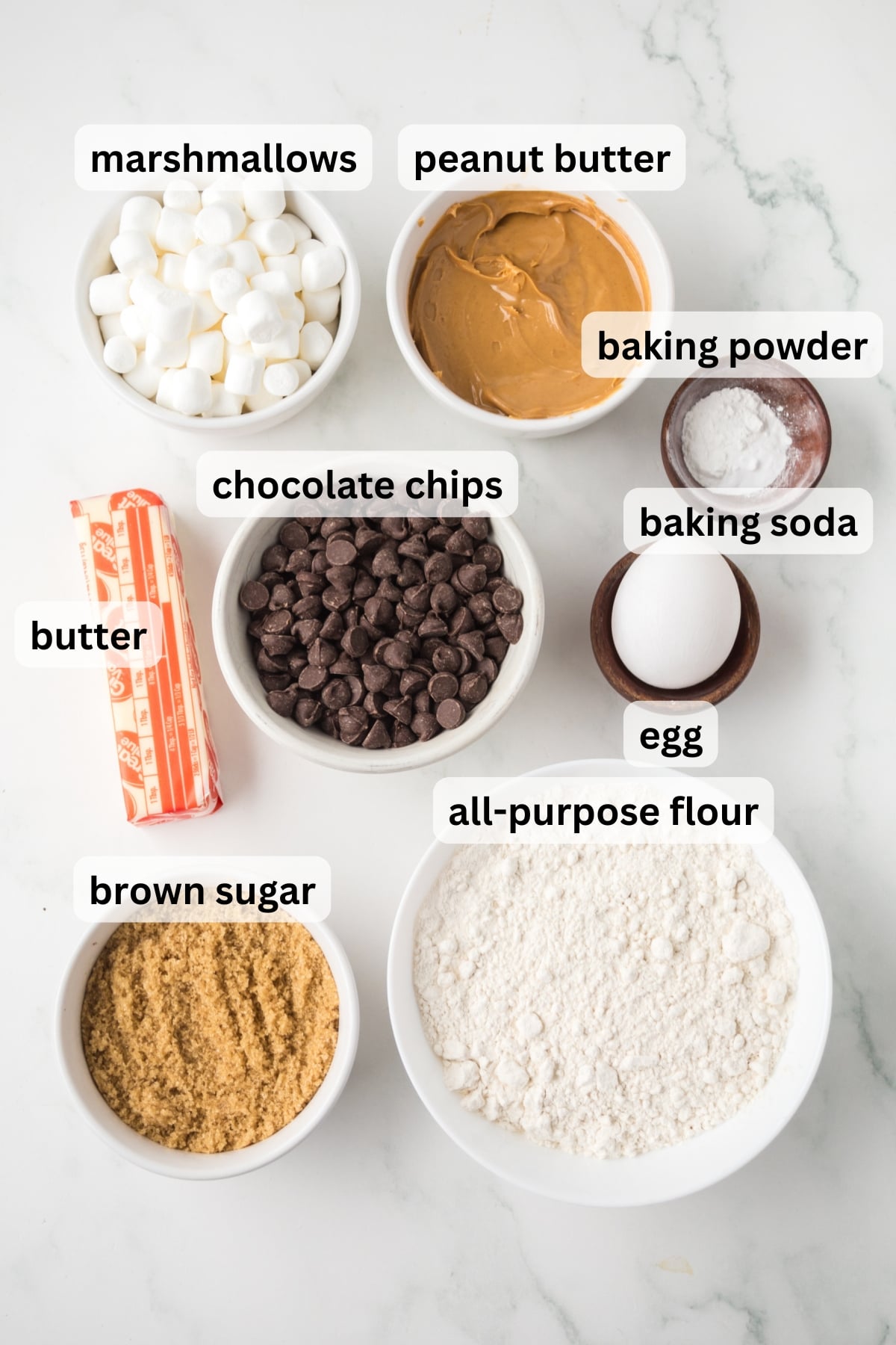Ingredients needed to make s'mores cookie bars arranged on a countertop.