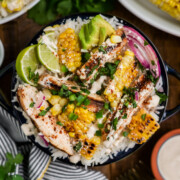 A Street Corn Chicken Rice Bowls on a table.