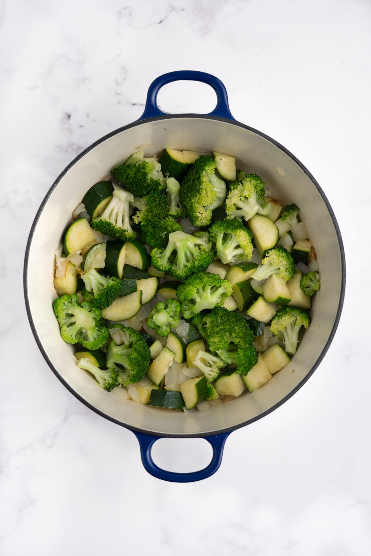 Veggies in a pot cooking down.