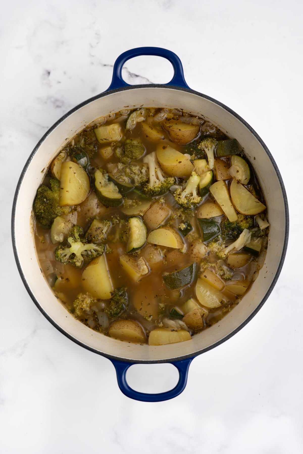 Broth and potatoes added to the pot.