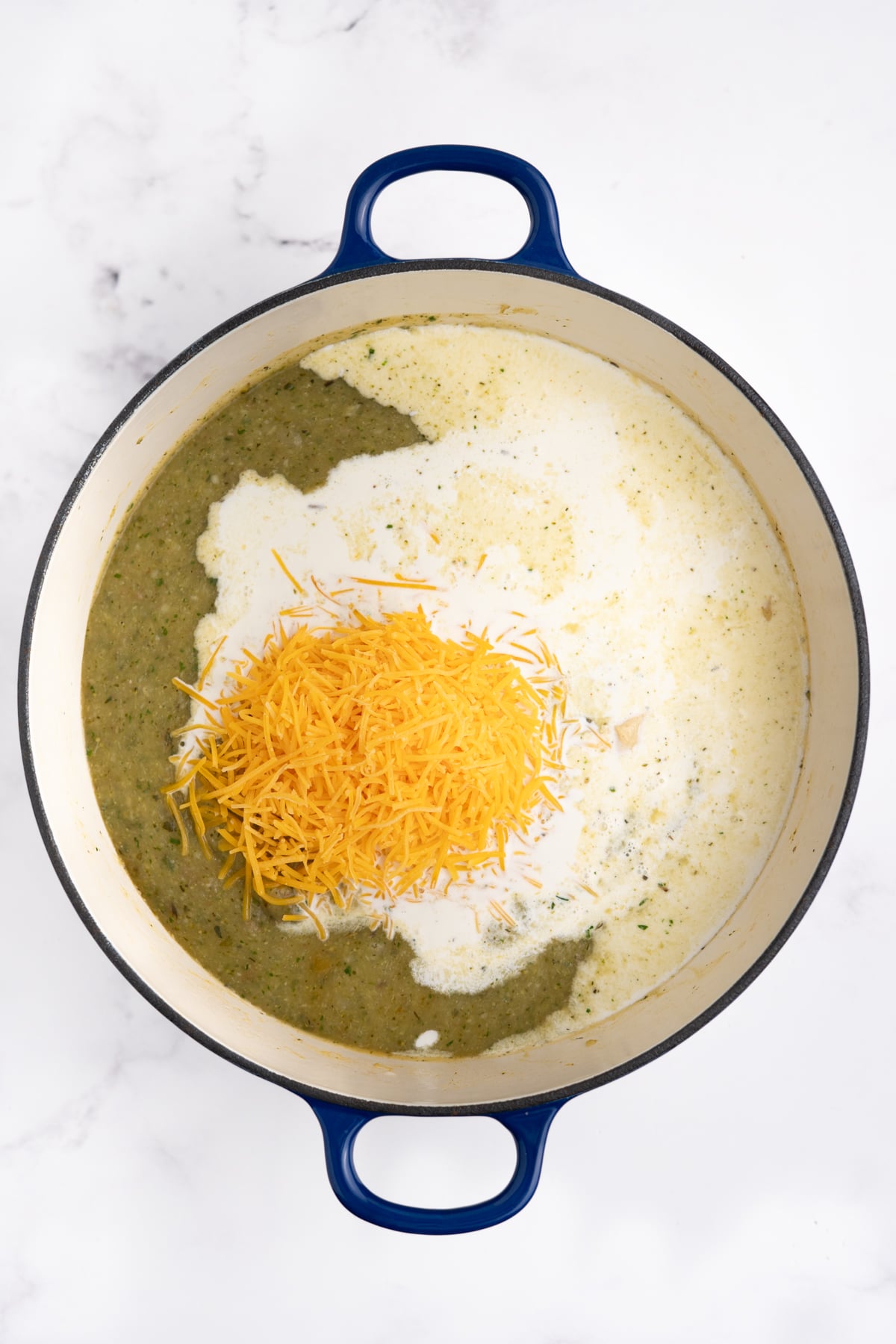Milk, cream, Dijon, and shredded cheddar added to finish the soup.
