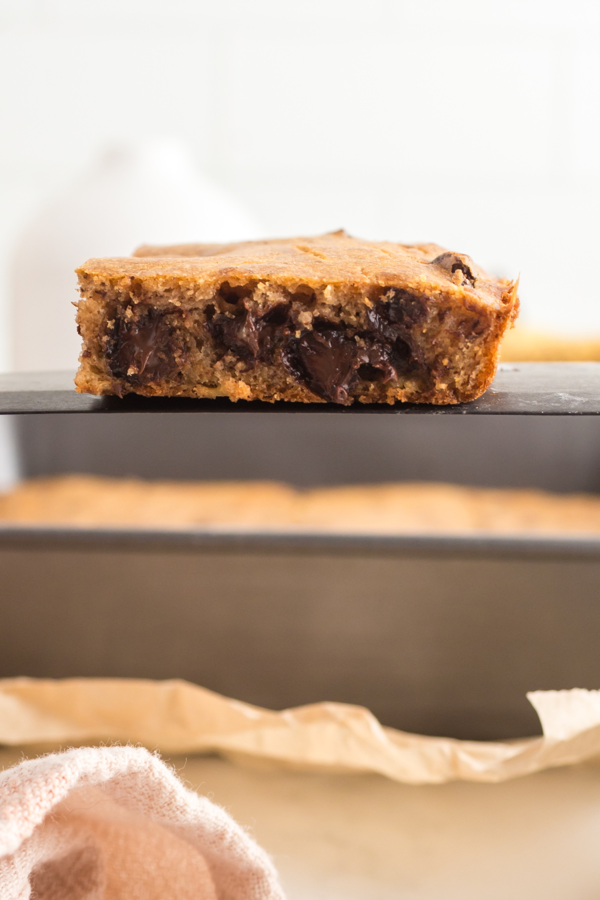 A banana blondie on a spatula held in the air