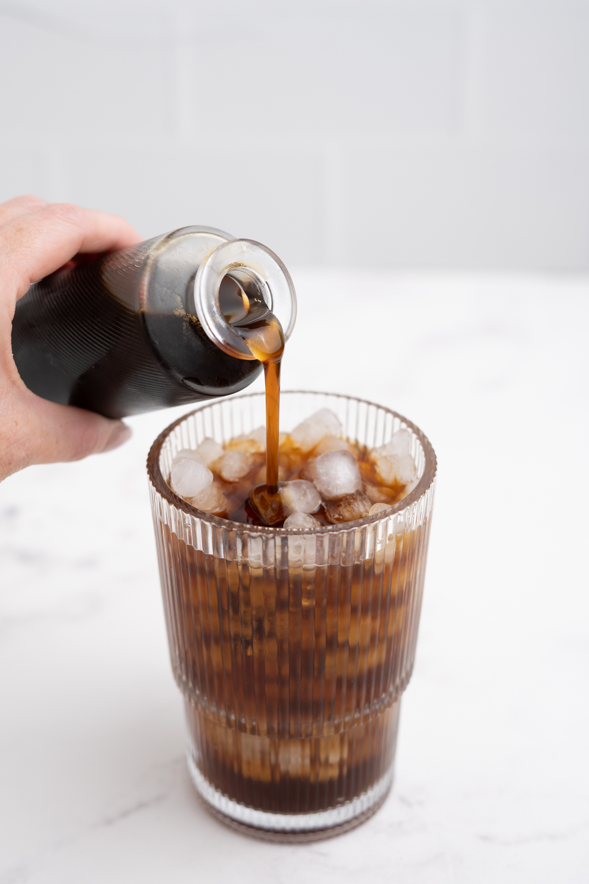 Apple syrup added to the glass.