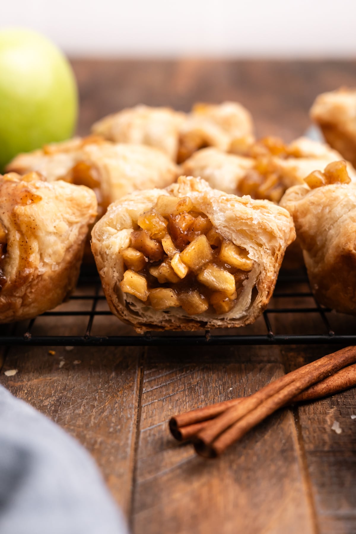 Croissant missing a bite on a cooling rack.
