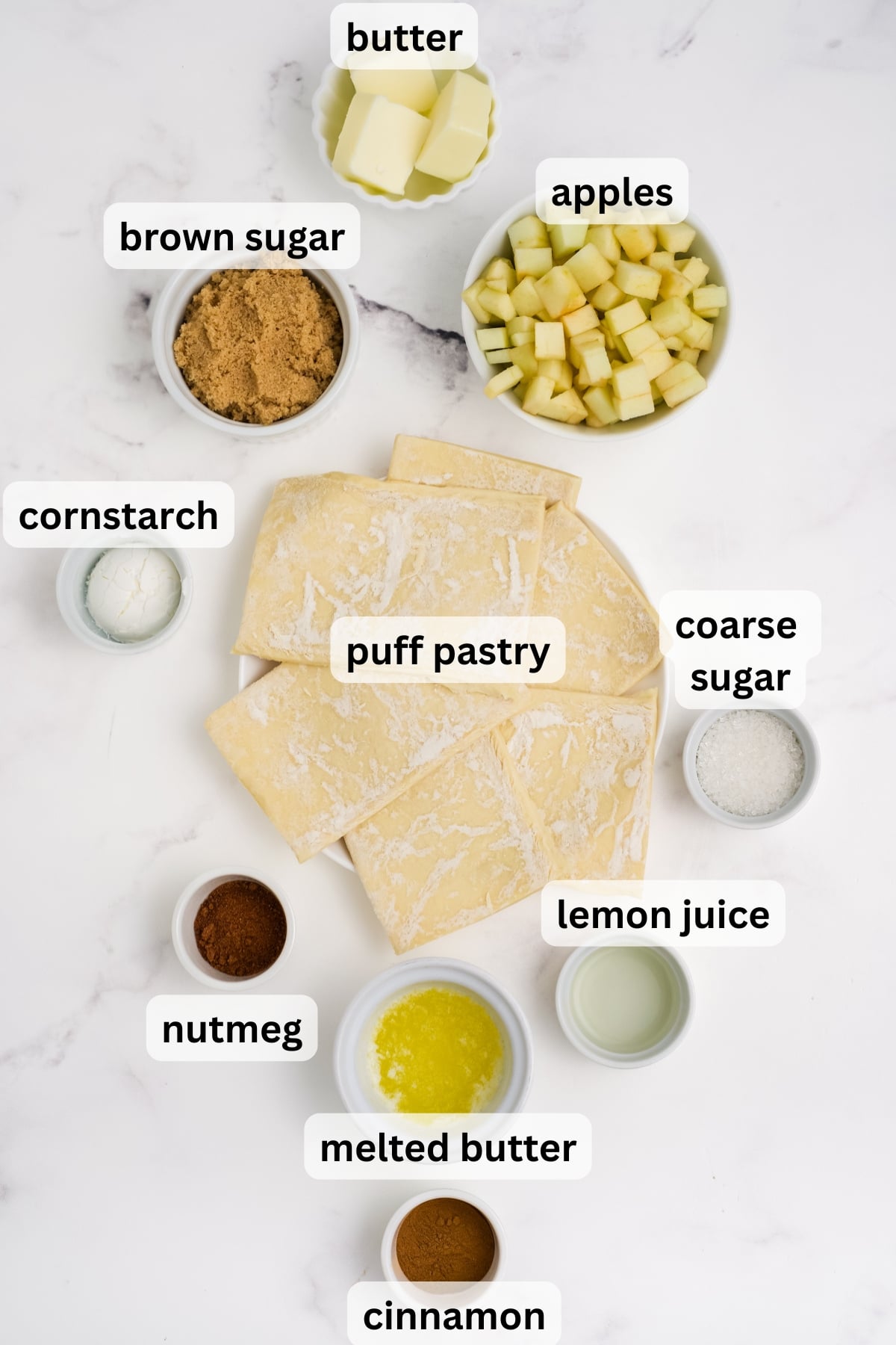All of the ingredients needed to make Apple Croissants in bowls on a table.