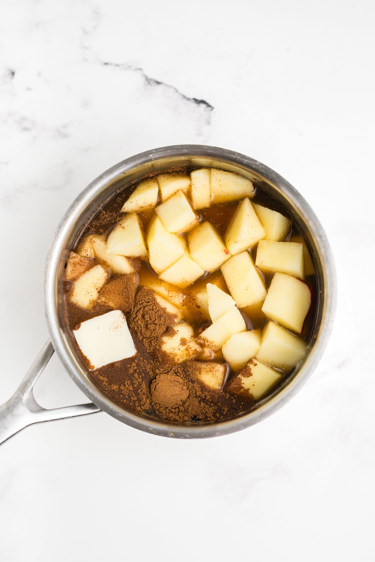 Apple syrup ingredients in a saucepan.