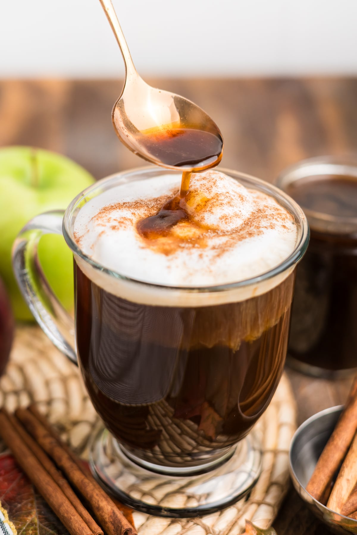 apple syrup drizzled over Apple Crisp Cold Foam on cold brew coffee.