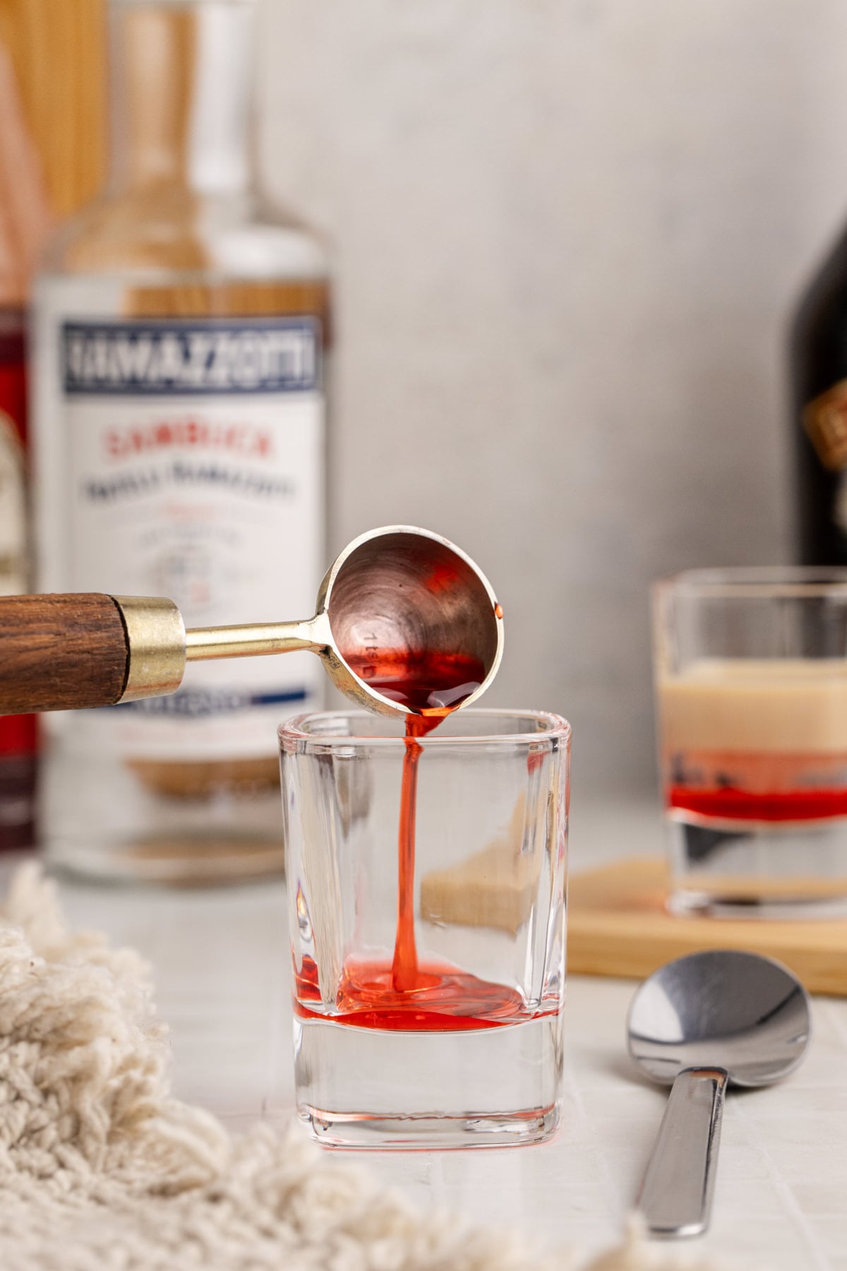 Grenadine added to shot glass.