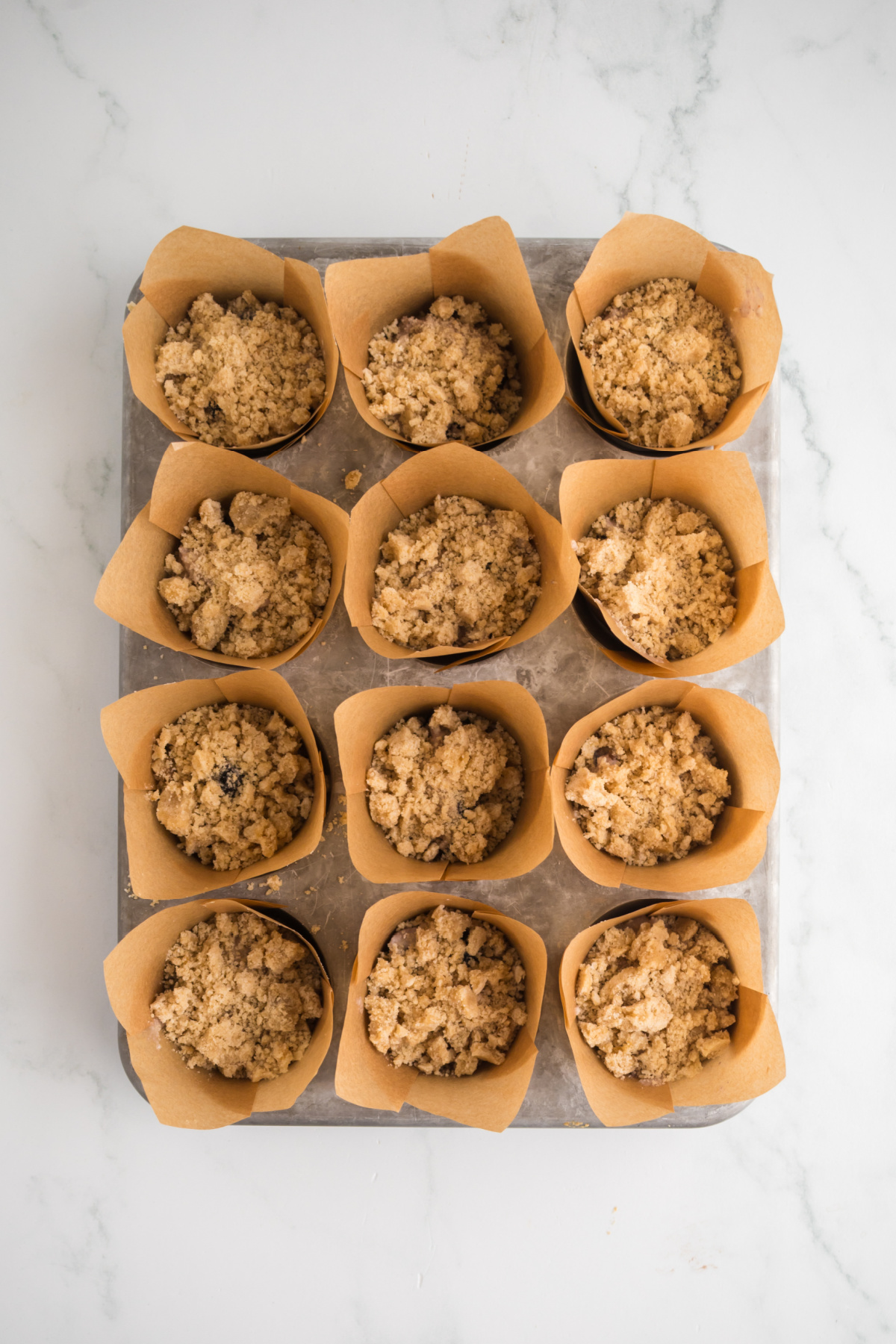Streusel is added to tops of muffins in pan.