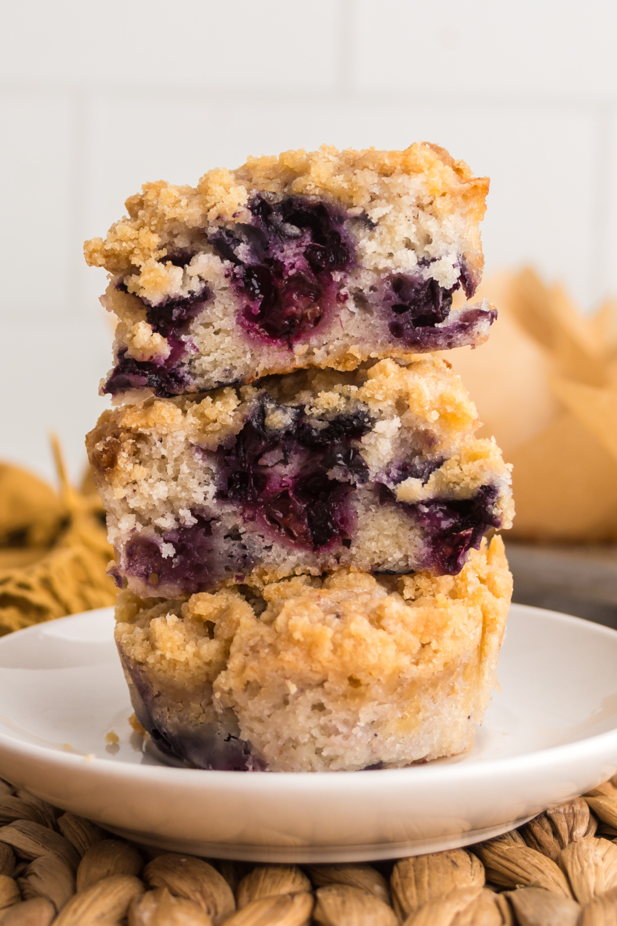 A stack of muffins with top two cut in half.