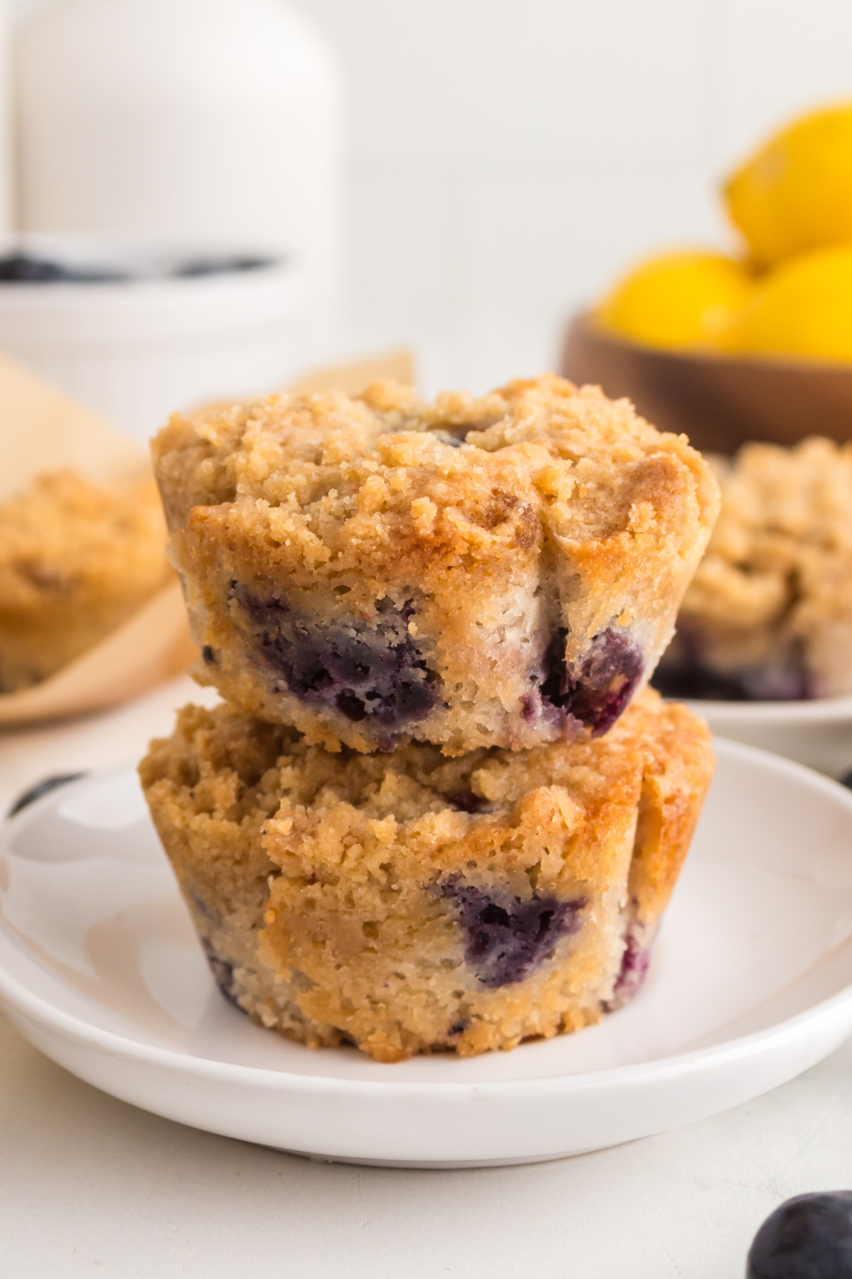 Two muffins on top of each other on a plate.