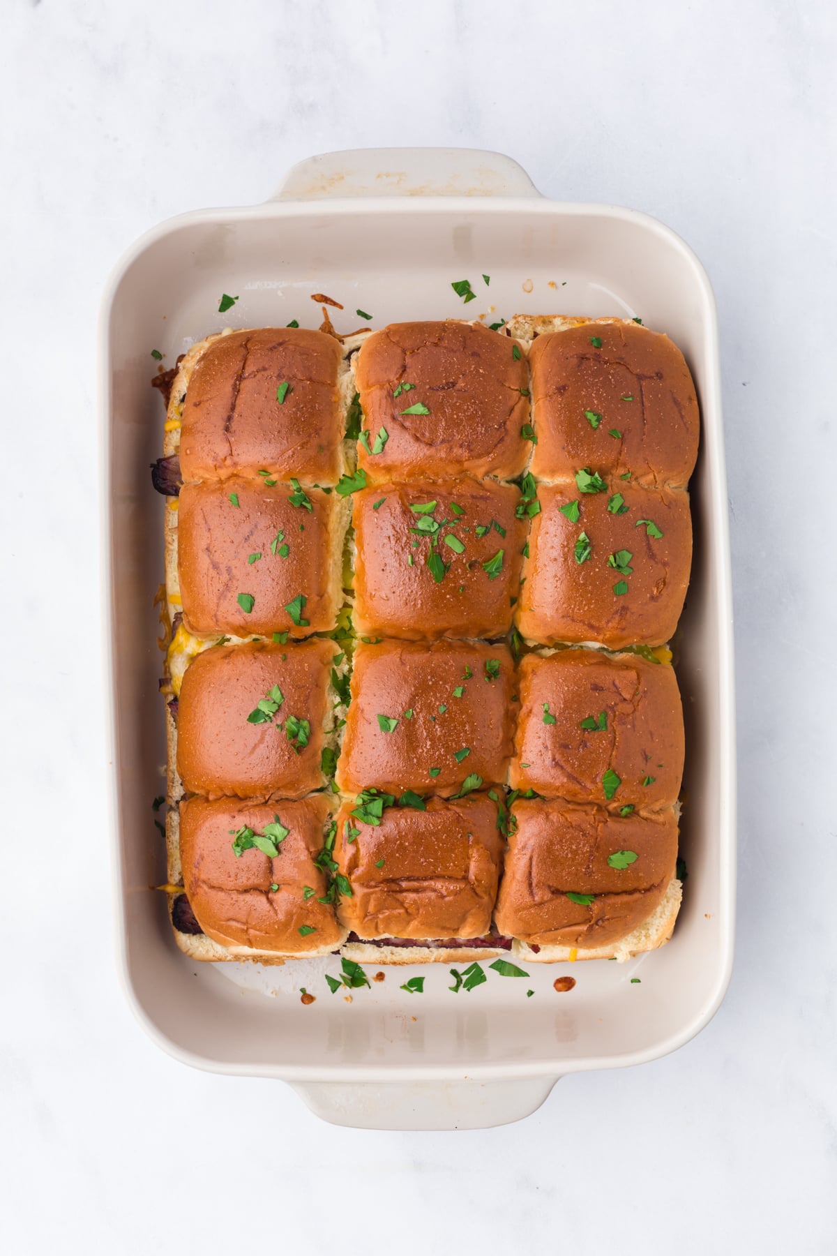 Freshly baked brisket sliders sliced and ready to serve.