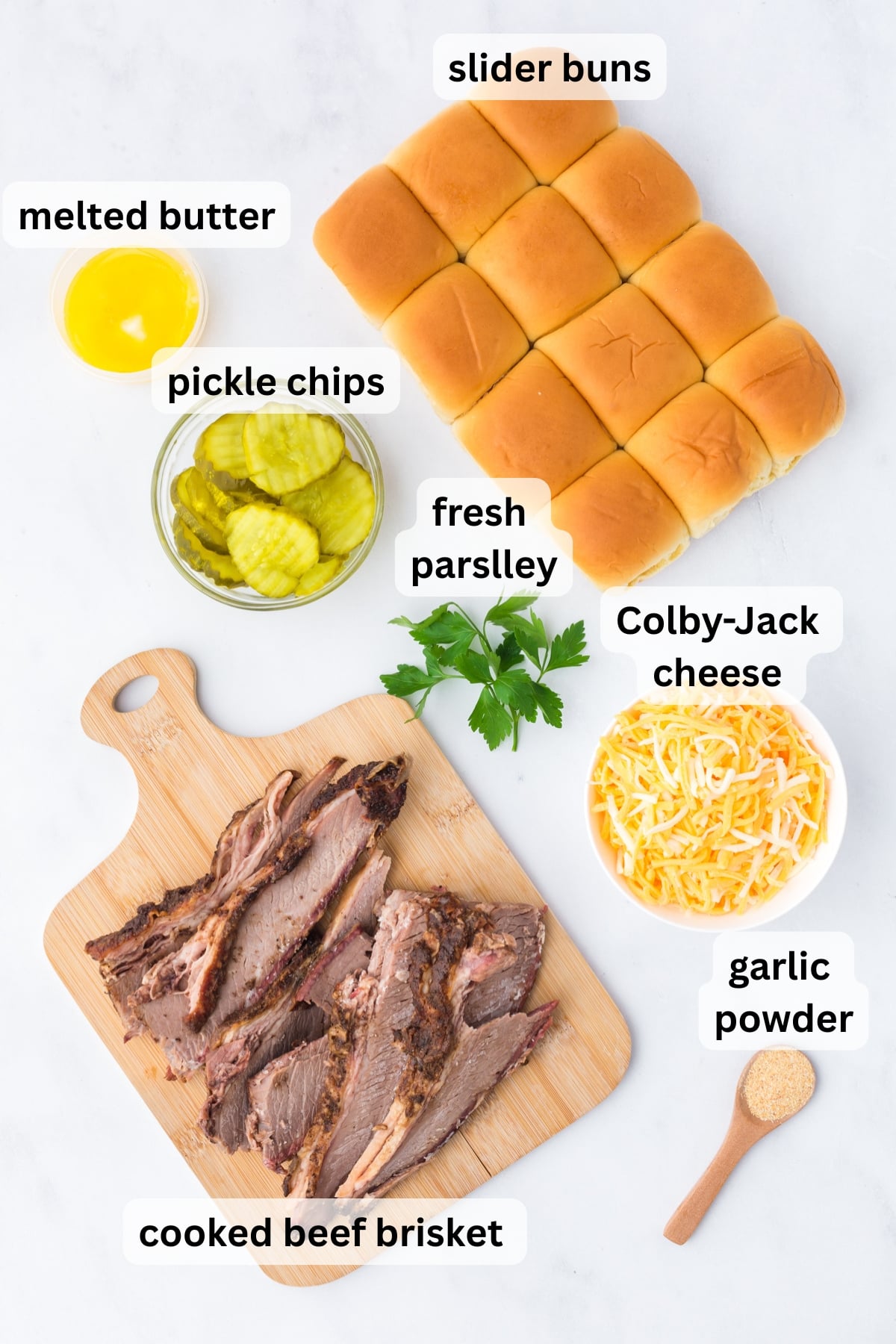 All of the ingredients needed to make Brisket Sliders in bowls on a table.