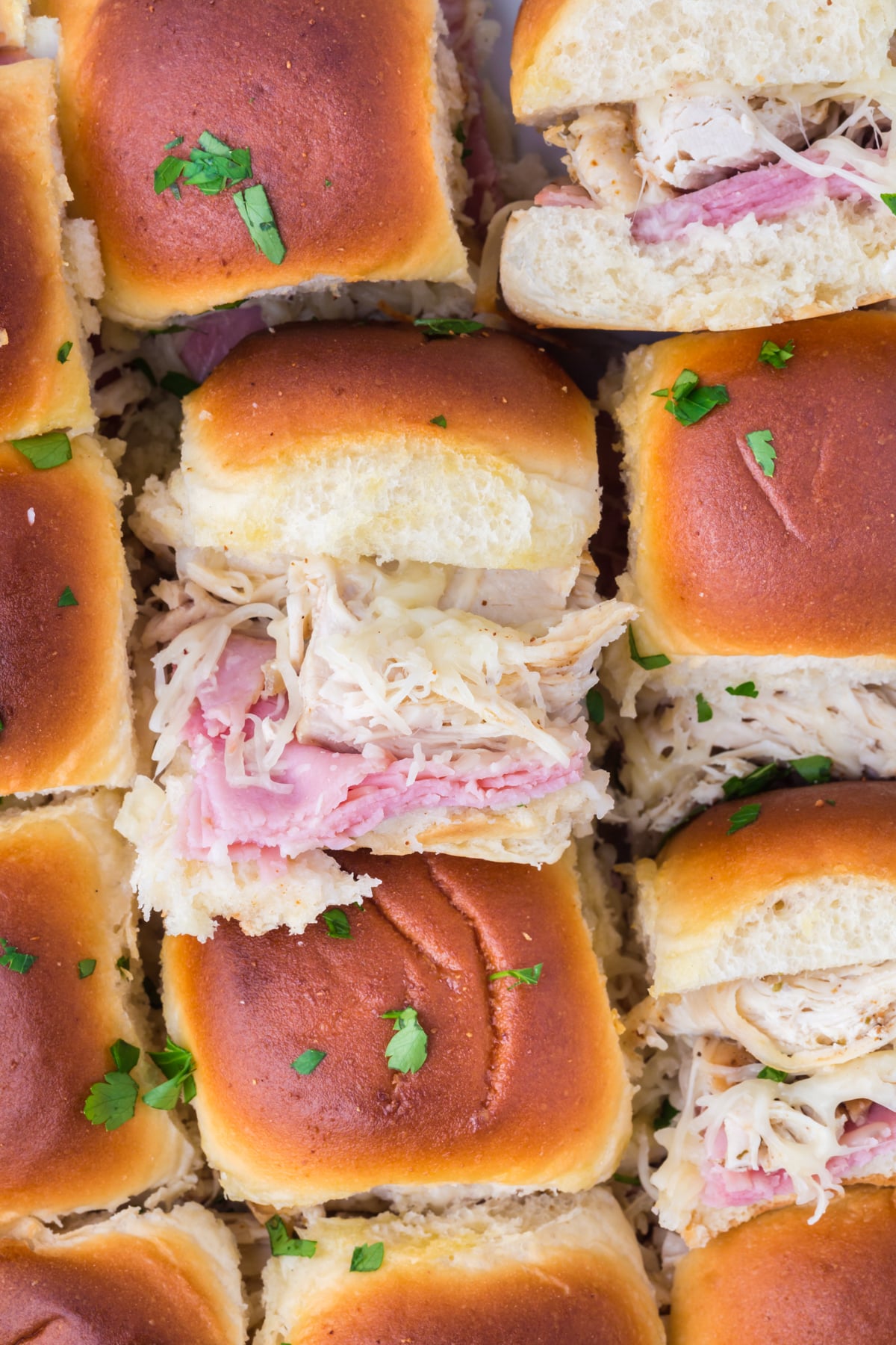 Sliders in casserole dish with some flipped on their side.