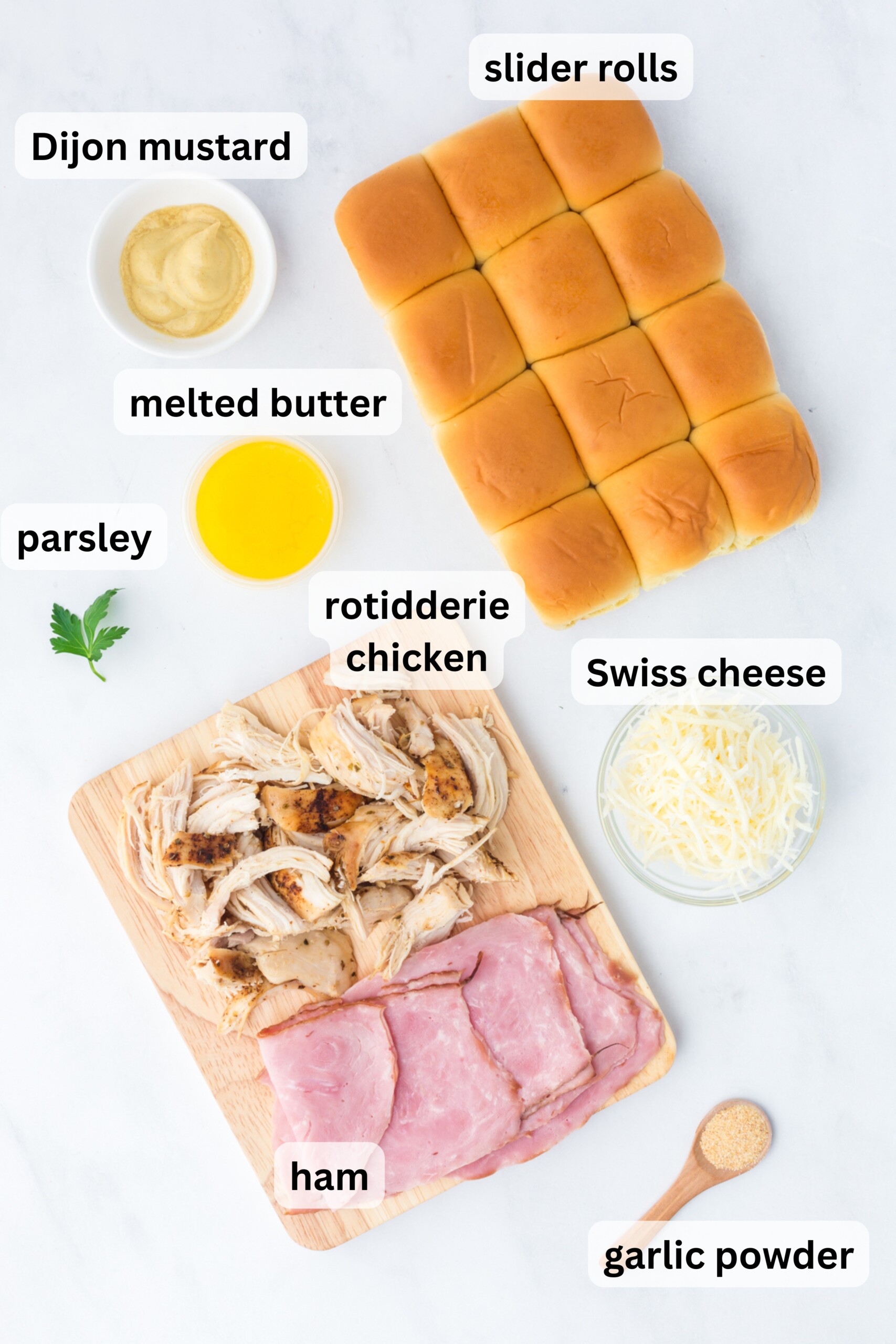 All of the ingredients needed to make Chicken Cordon Bleu Sliders on a table.