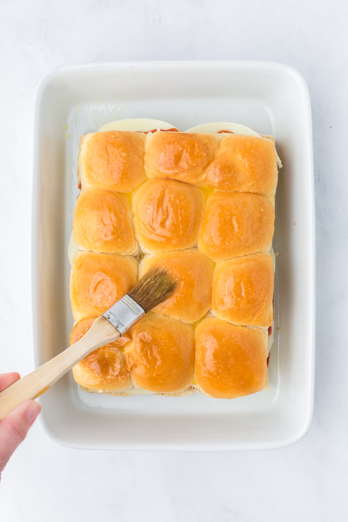 Garlic butter brushed over Sliders before baking.