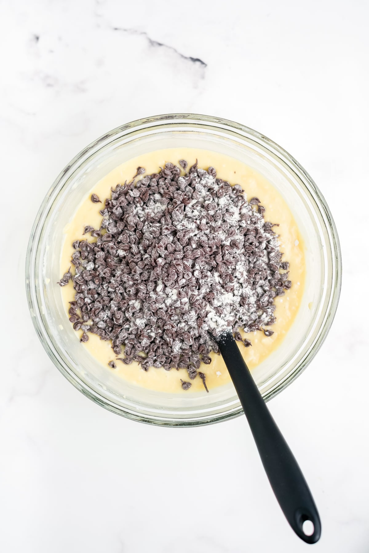 Flour coated chocolate chips added to cake batter.