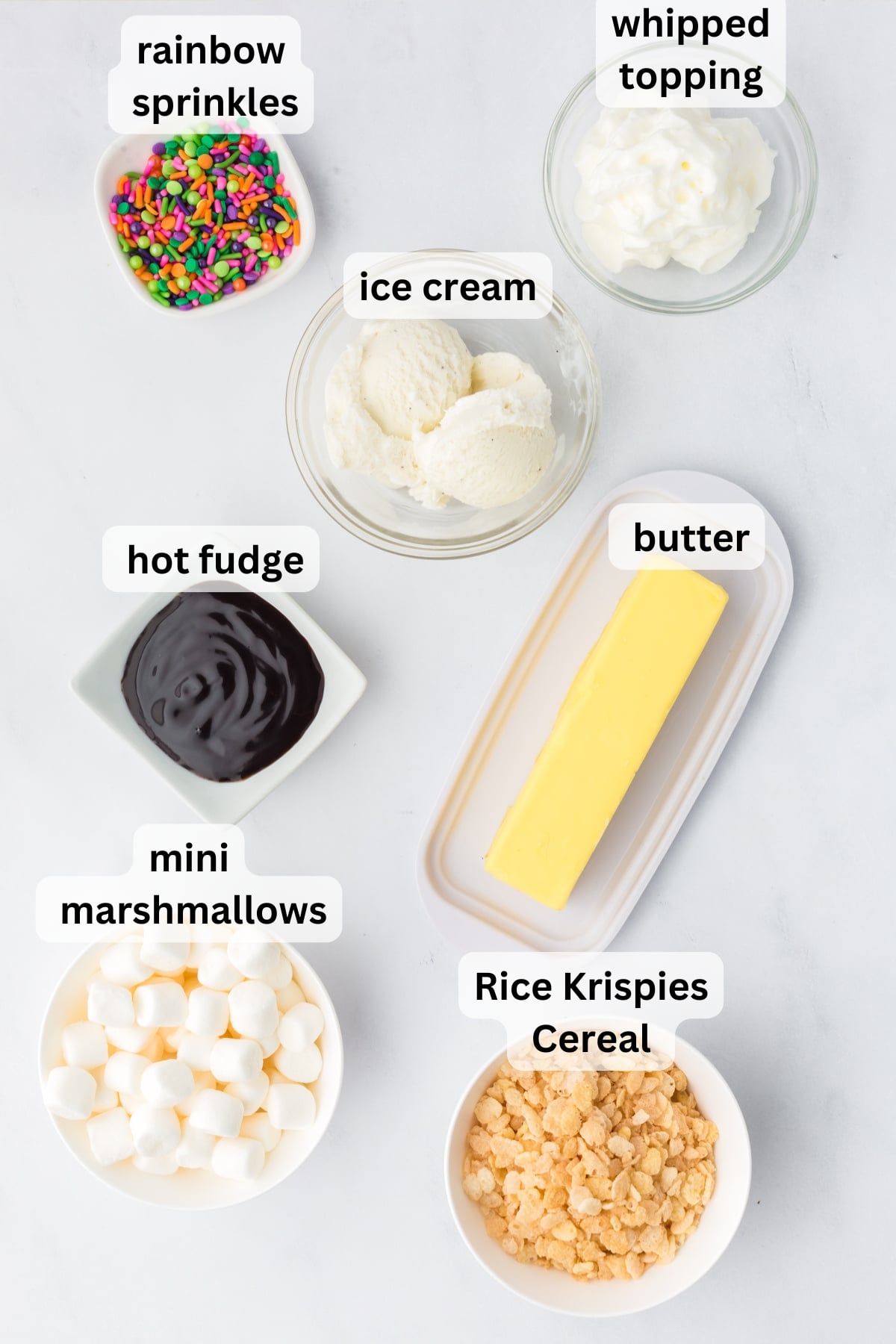 All of the ingredients needed to make edible ice cream bowls in bowls on a table.
