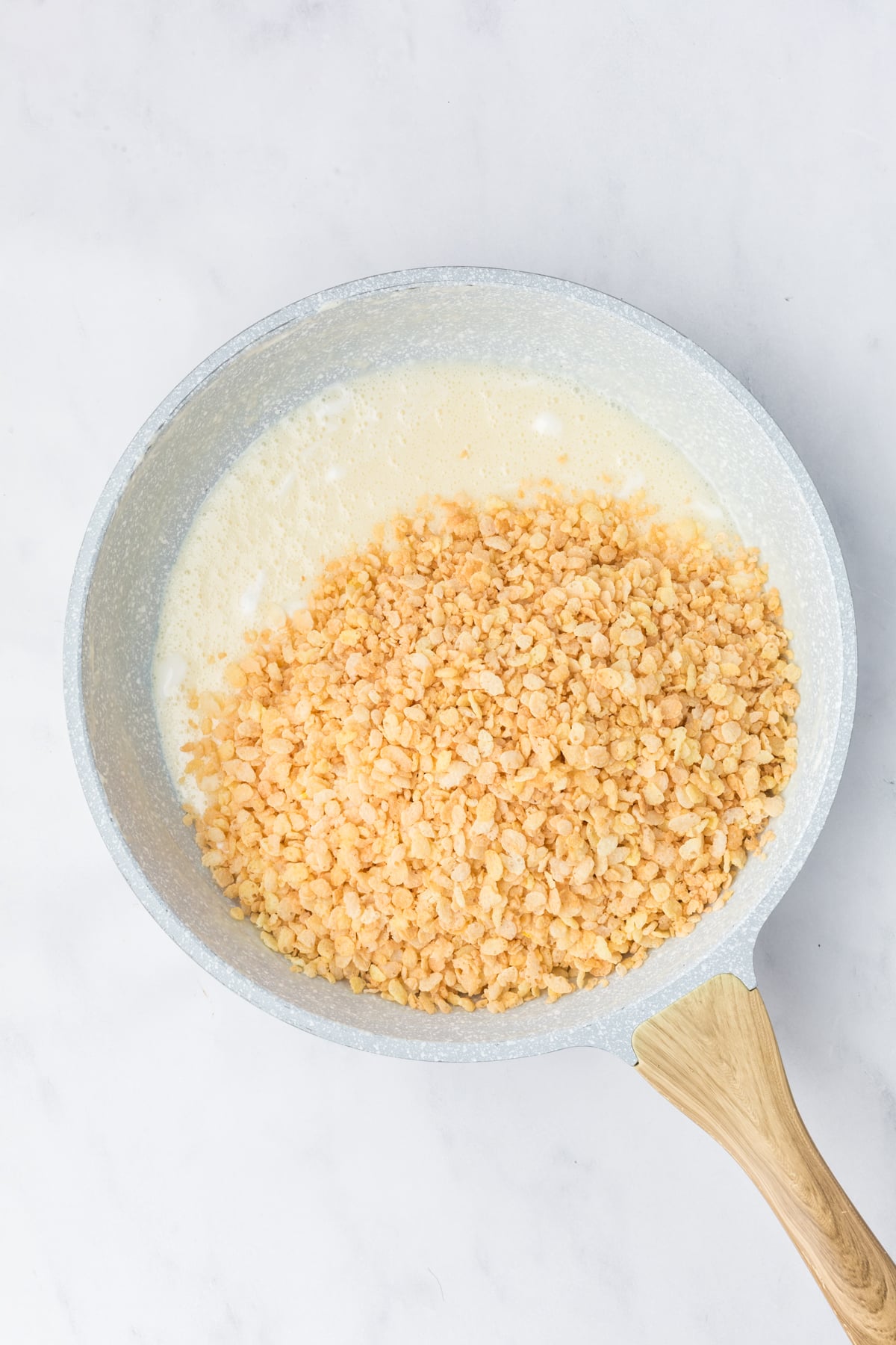 Melted butter and marshmallows in large nonstick skillet removed from heat with Rice Krispies added. 