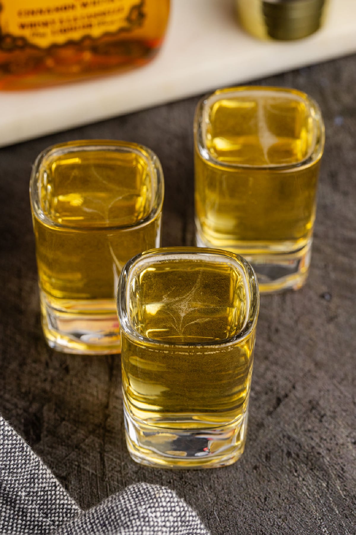 Three shots on a wood table.