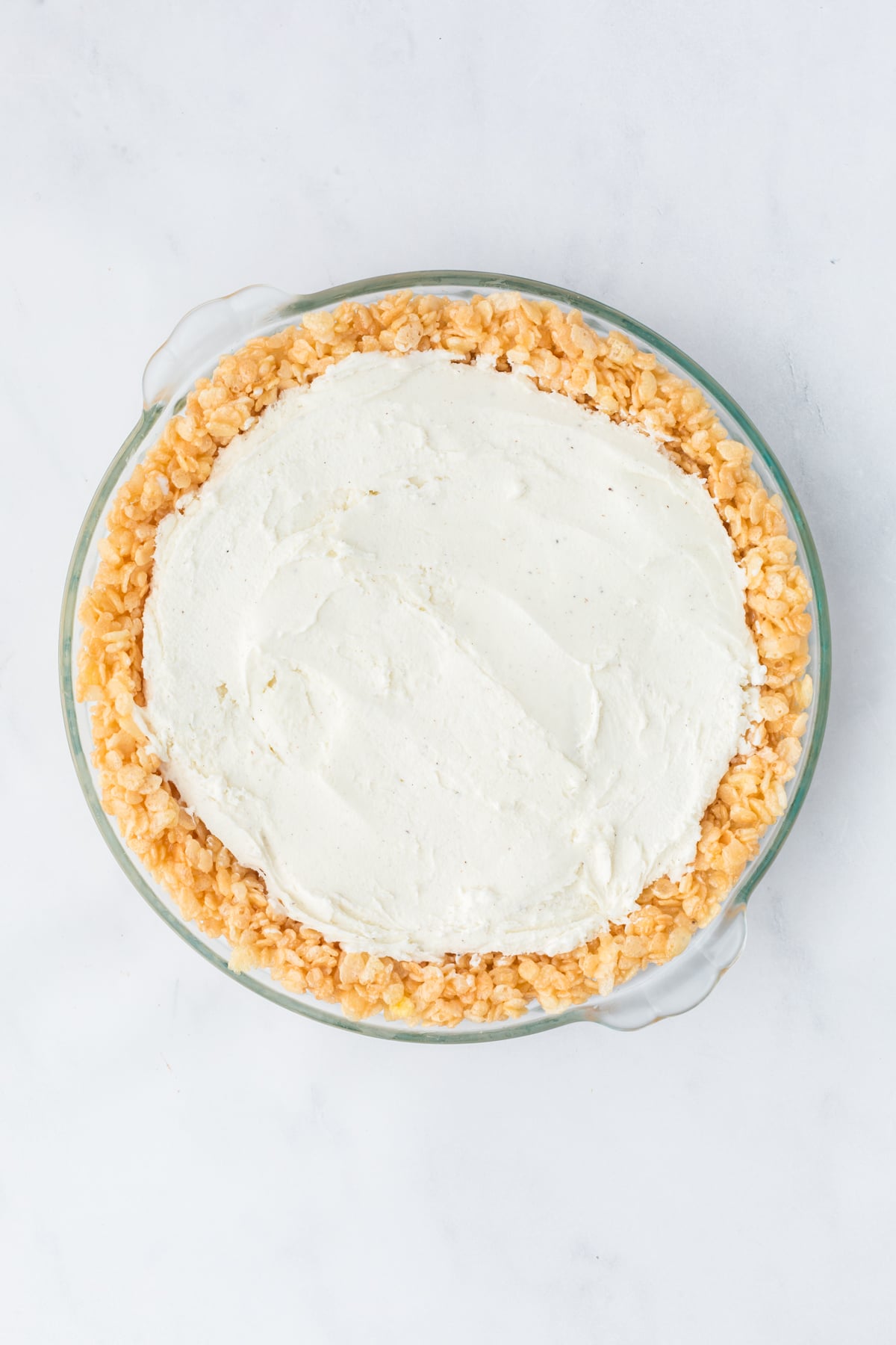 Softened ice cream added on top of Rice Krispie crust.