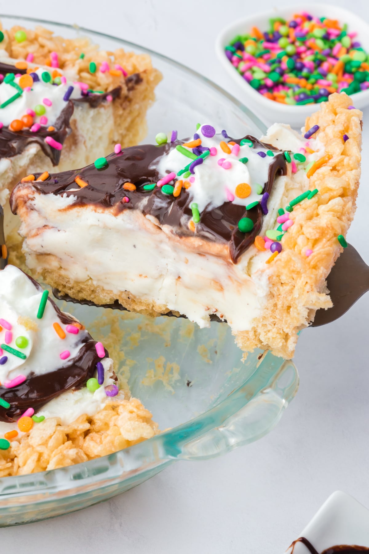 A slice of Ice Cream Pie being lifted out of the pie plate.