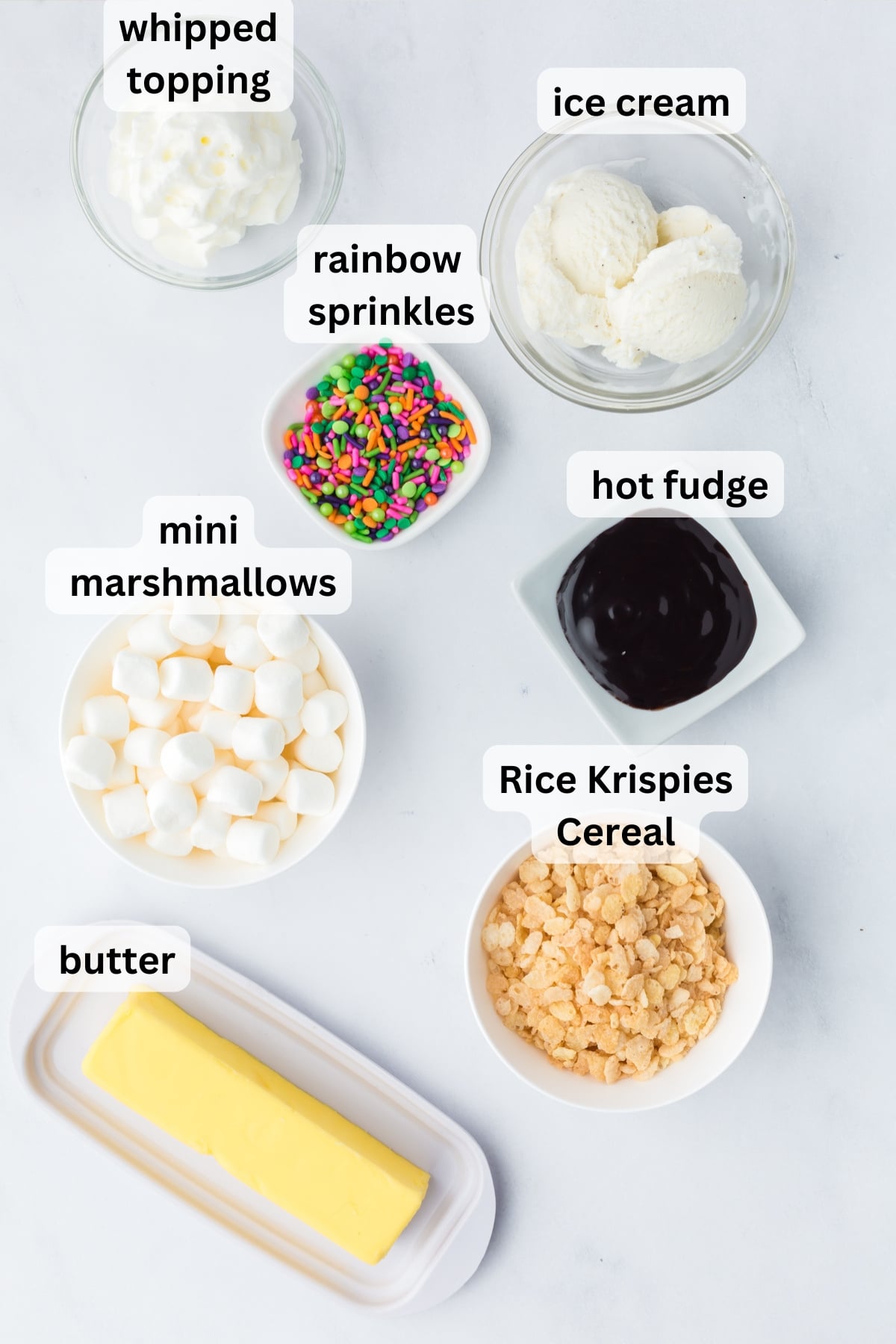 All of the ingredients needed to make Ice Cream Pie with Rice Krispie Crust in bowls on a table.