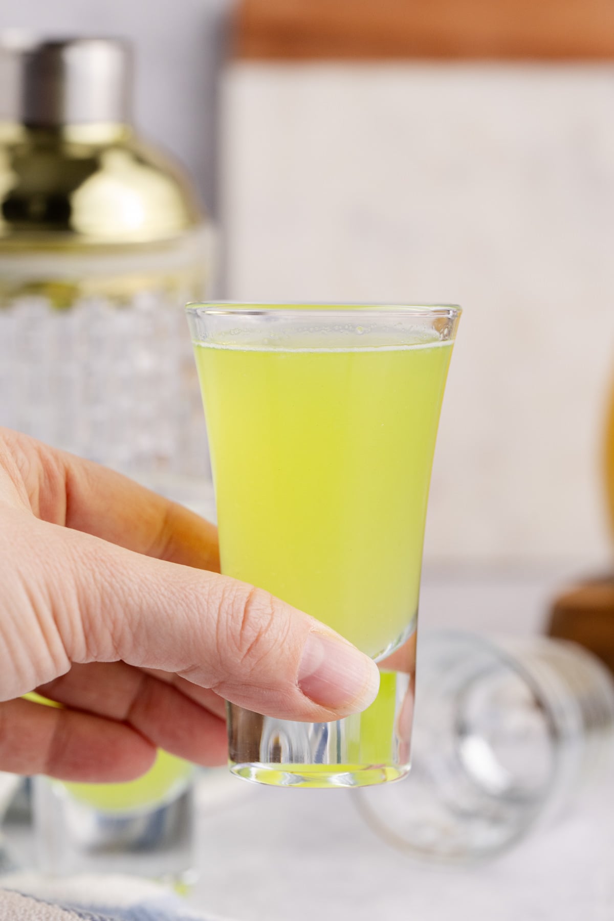 A shot held in the air ready to drink.