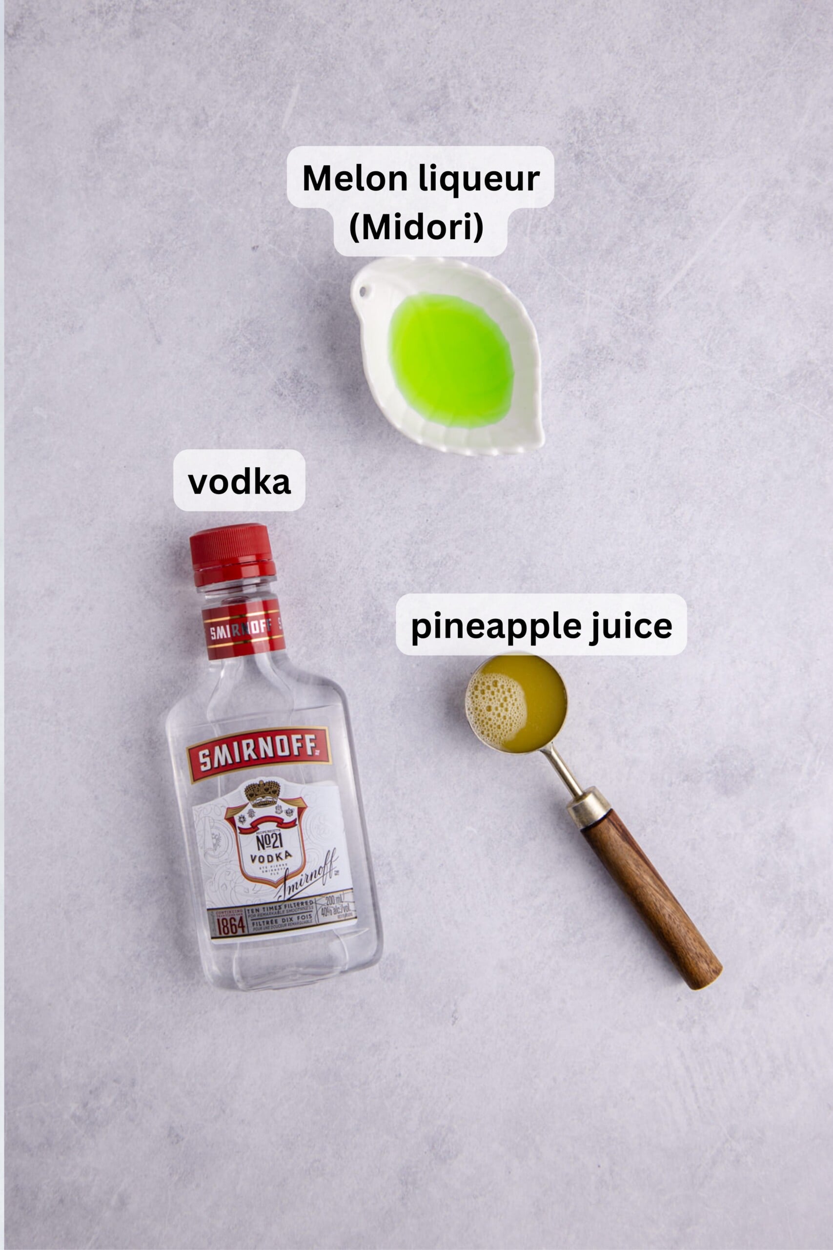 All of the ingredients needed to make a melon ball shot on a table.