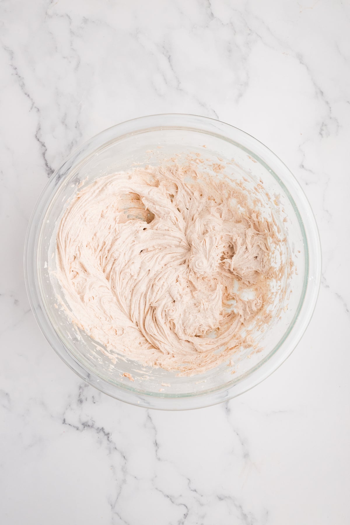 Frosting being mixed until smooth and fluffy.