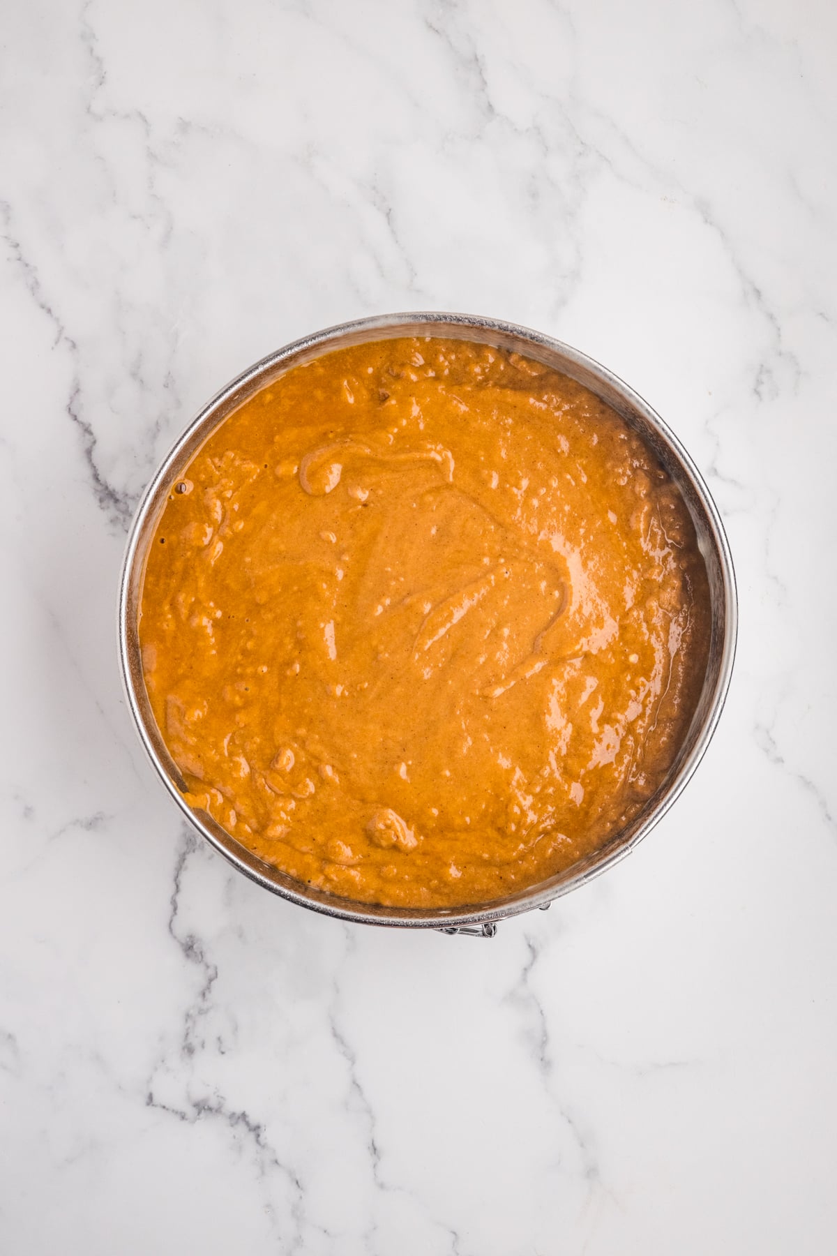 Ccake batter poured into a prepared cake pan.