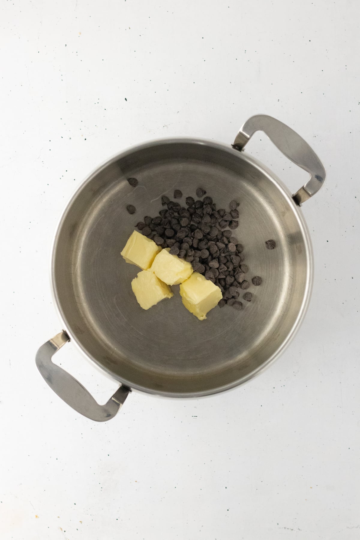 Butter and chocolate chips melting in a saucepan.