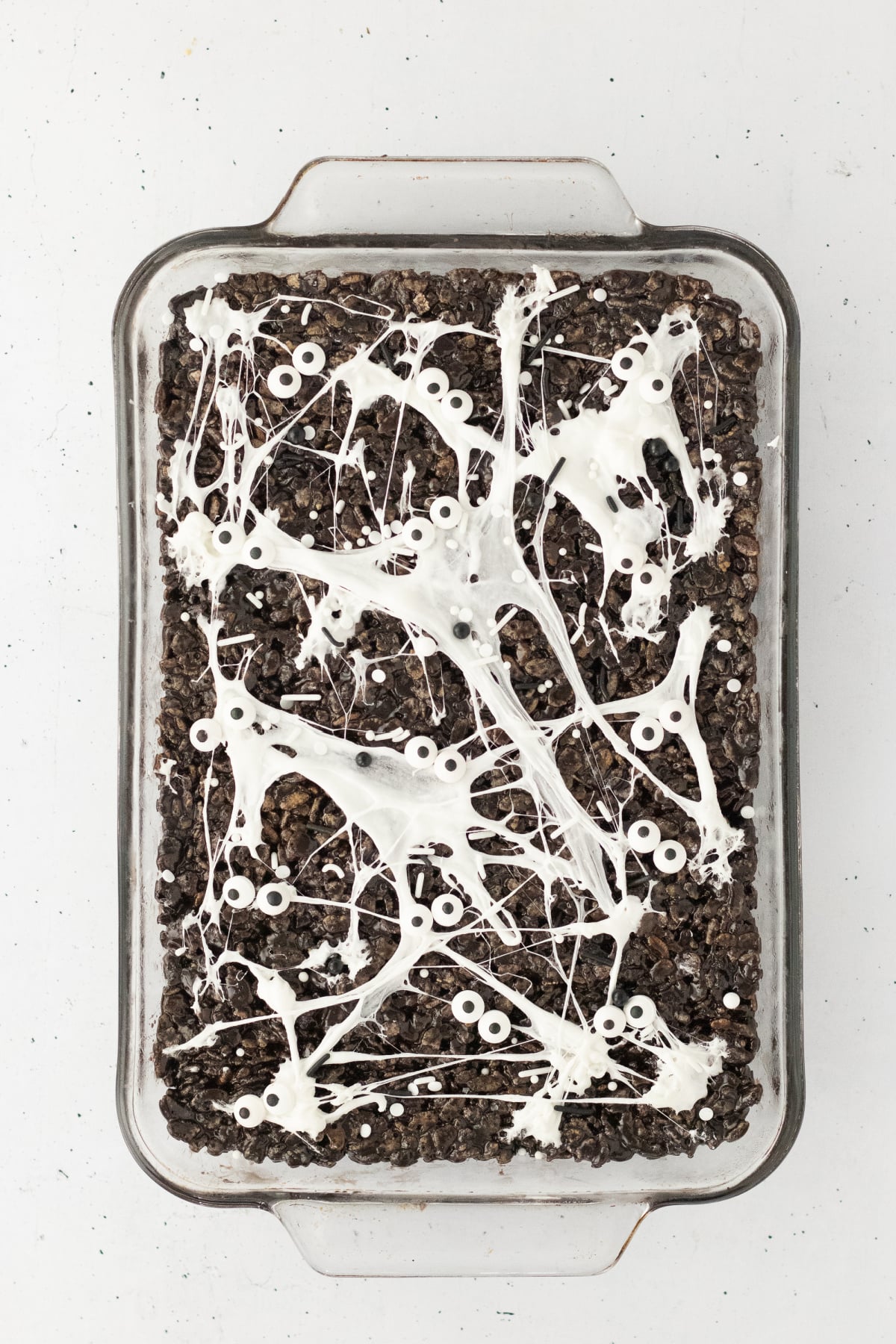 Baking dish covered in melted marshmallows, sprinkles and edible eyes.