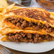 Sloppy Joe Grilled Cheese sandwiches stacked on a plate.