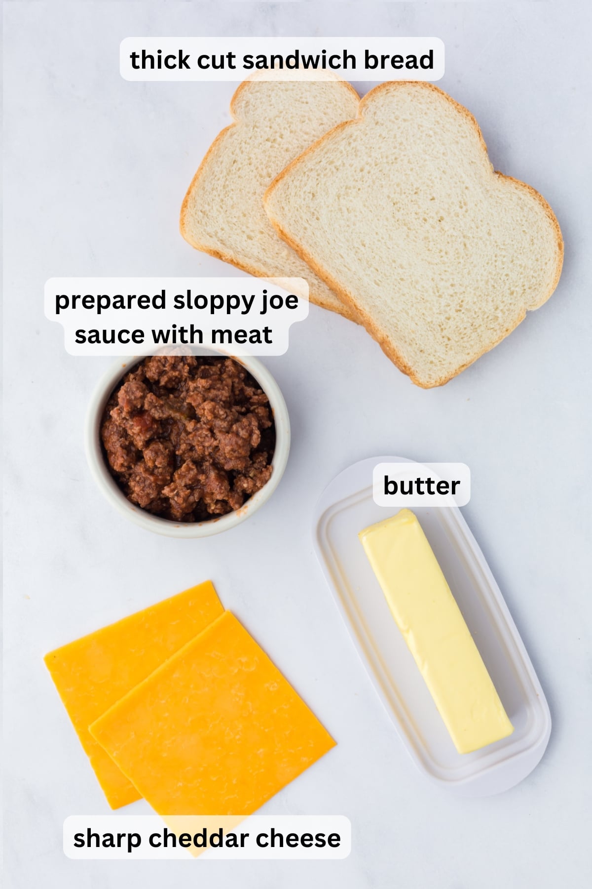 All of the Ingredients needed to make Sloppy Joe Grilled Cheese on a table.