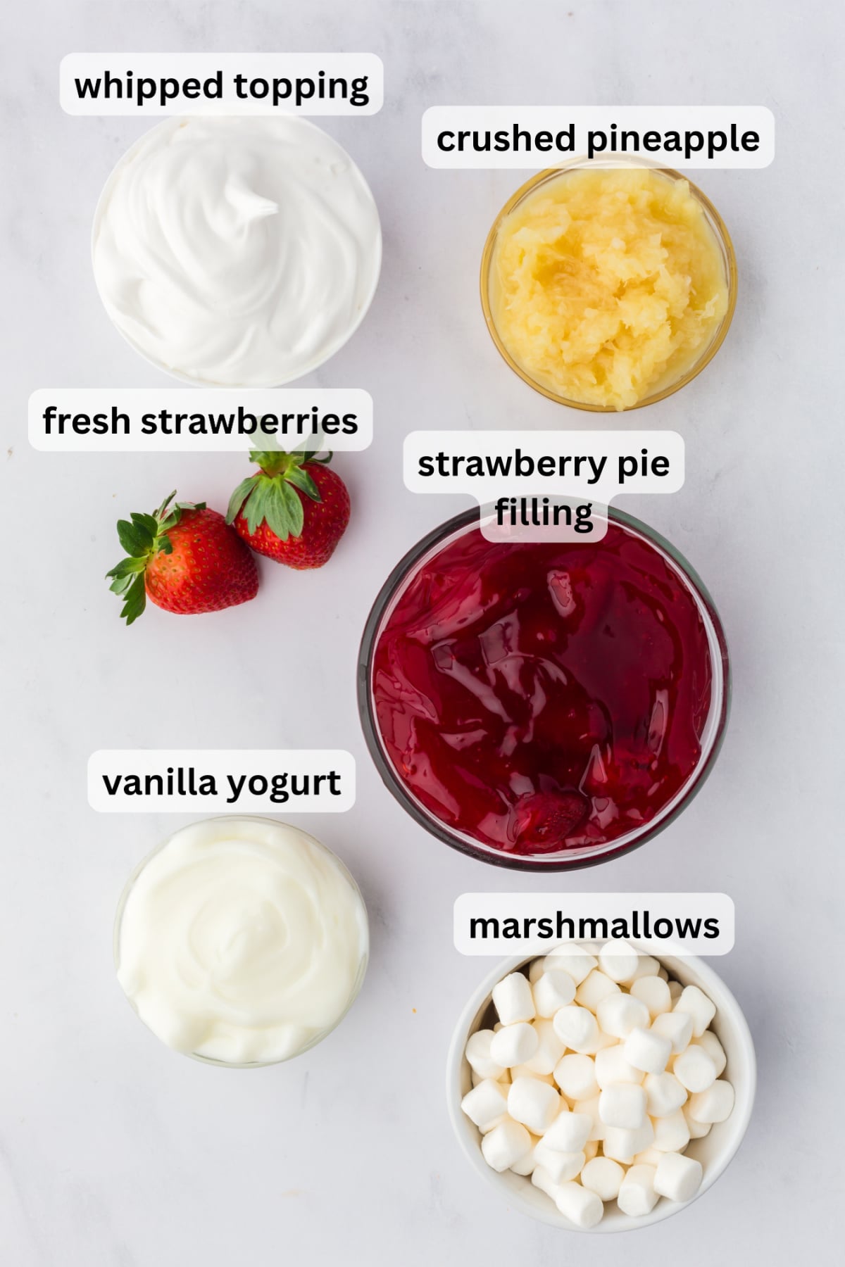 All of the ingredients needed to make Strawberry Fluff Salad with Pineapple in bowls on a table.