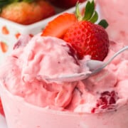 A spoonful of Strawberry Fluff Salad with Pineapple lifted out of the glassful.
