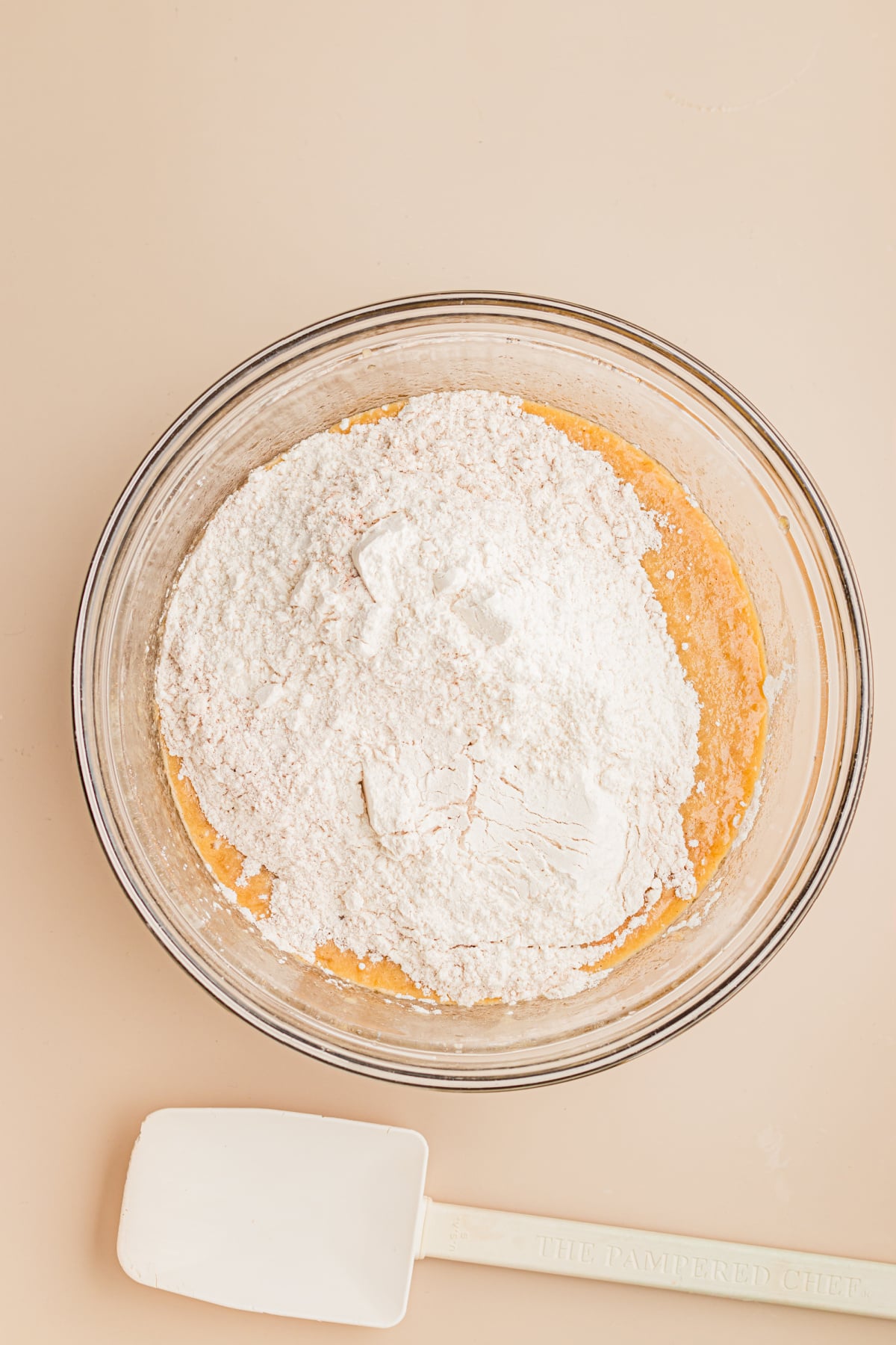 The mixed wet ingredients in bowl with dry ingredients added on top.