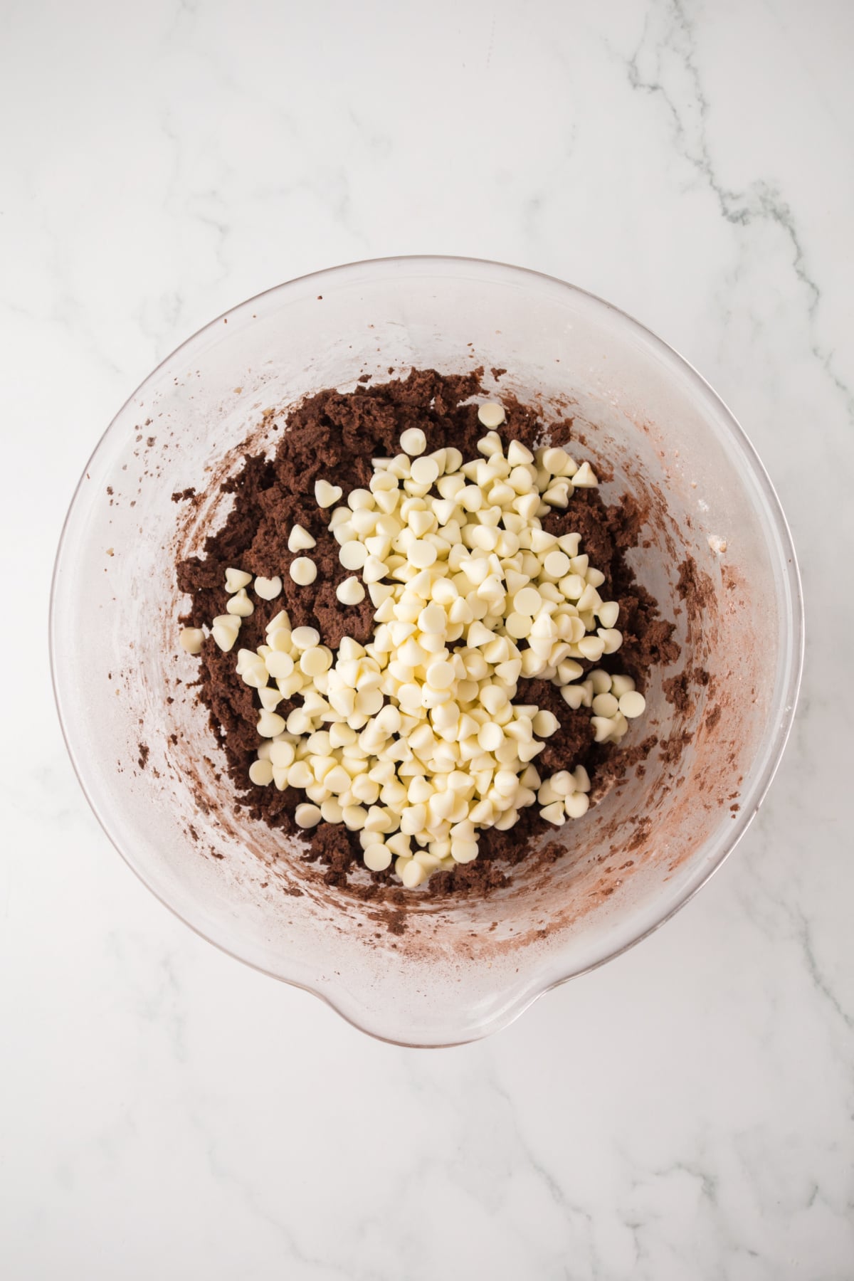 Dry ingredients and white chocolate chips added to the bowl.