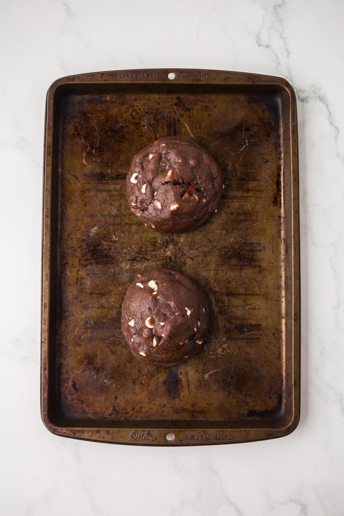 The cookie cooling on the baking tray.