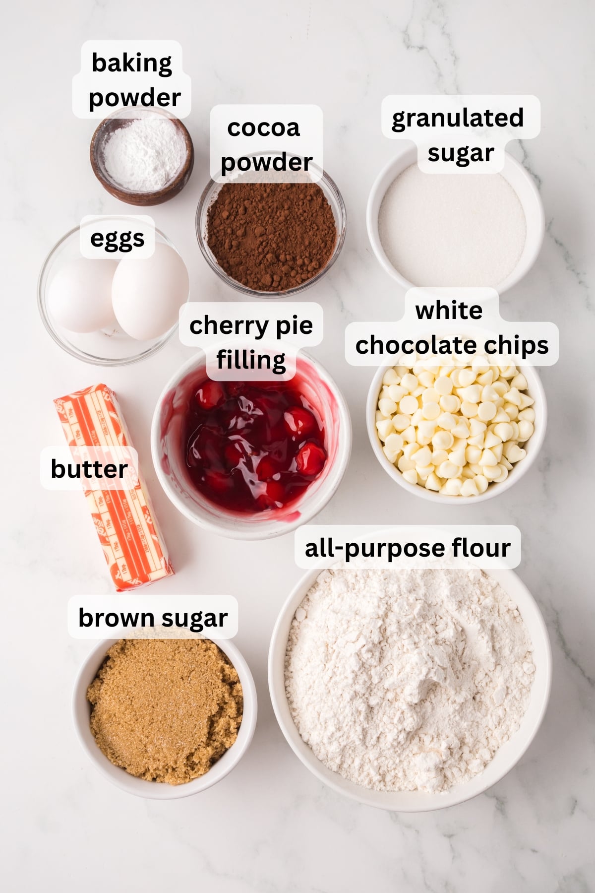 Ingredients to make these cherry chocolate cookies in bowls on a table.