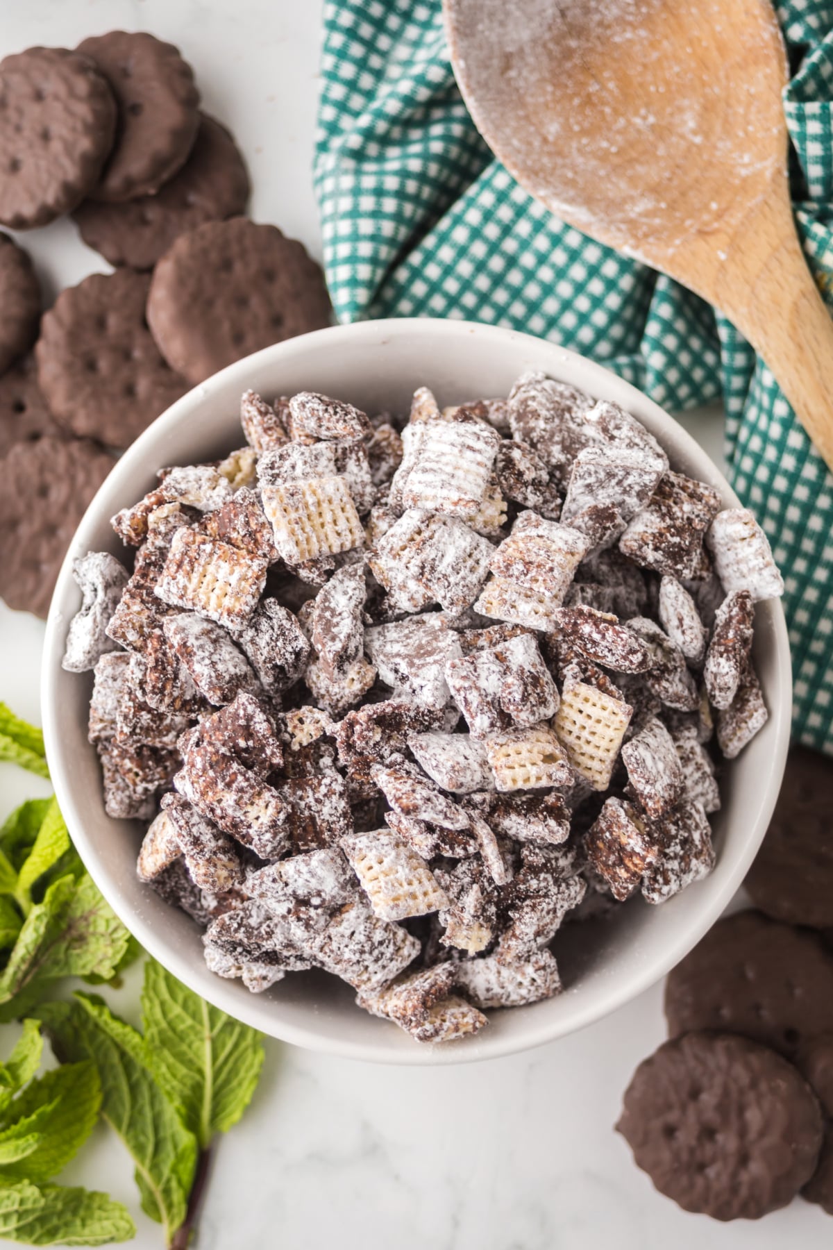 A bowl of muddy buddies on a table.