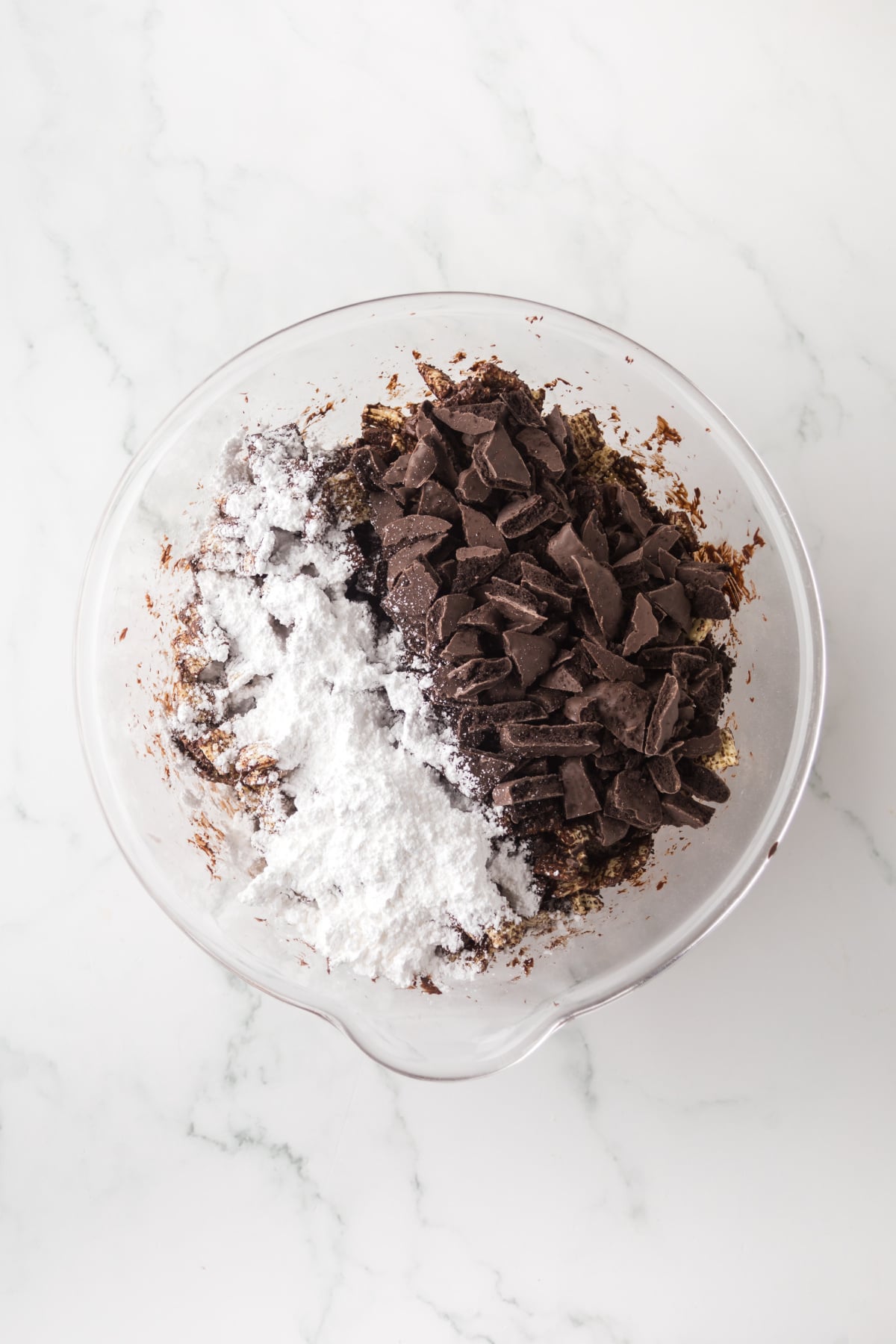 Chocolate coated Chex cereal covered in powdered sugar and crushed thin mints cookies.