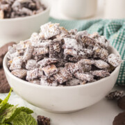 A bowl of mint muddy buddies on a table.