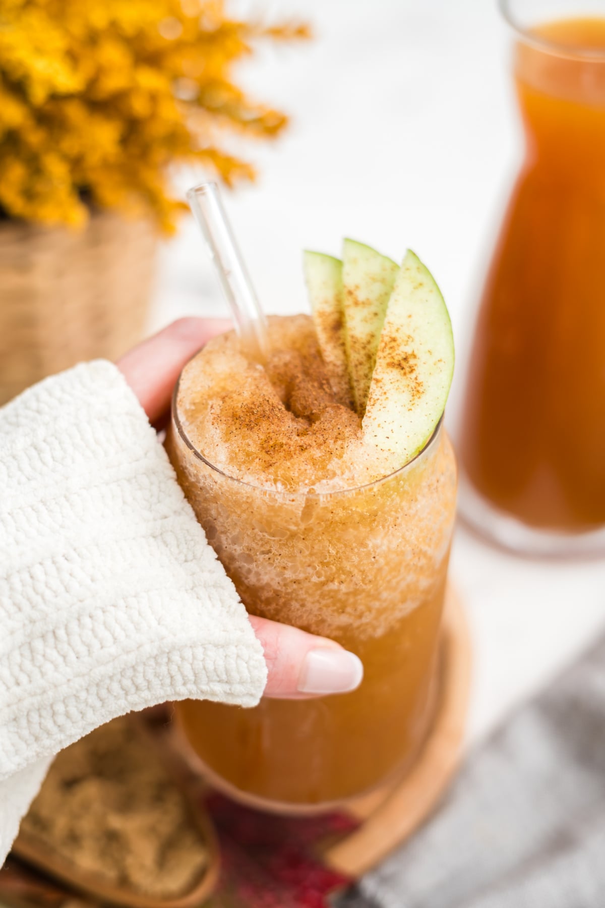 A hand holding a slushie in the air.