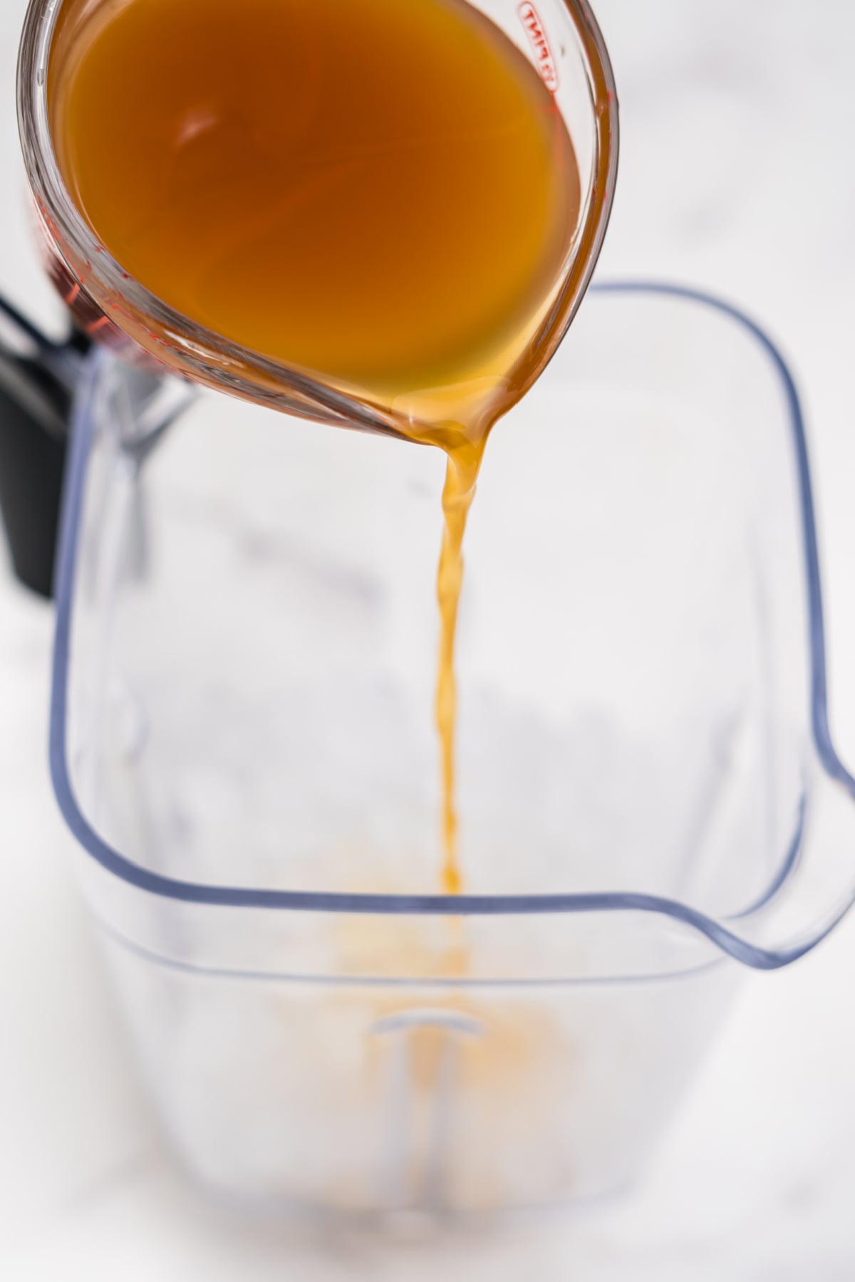 Apple cider, ice, brown sugar, and cinnamon added to a blender.