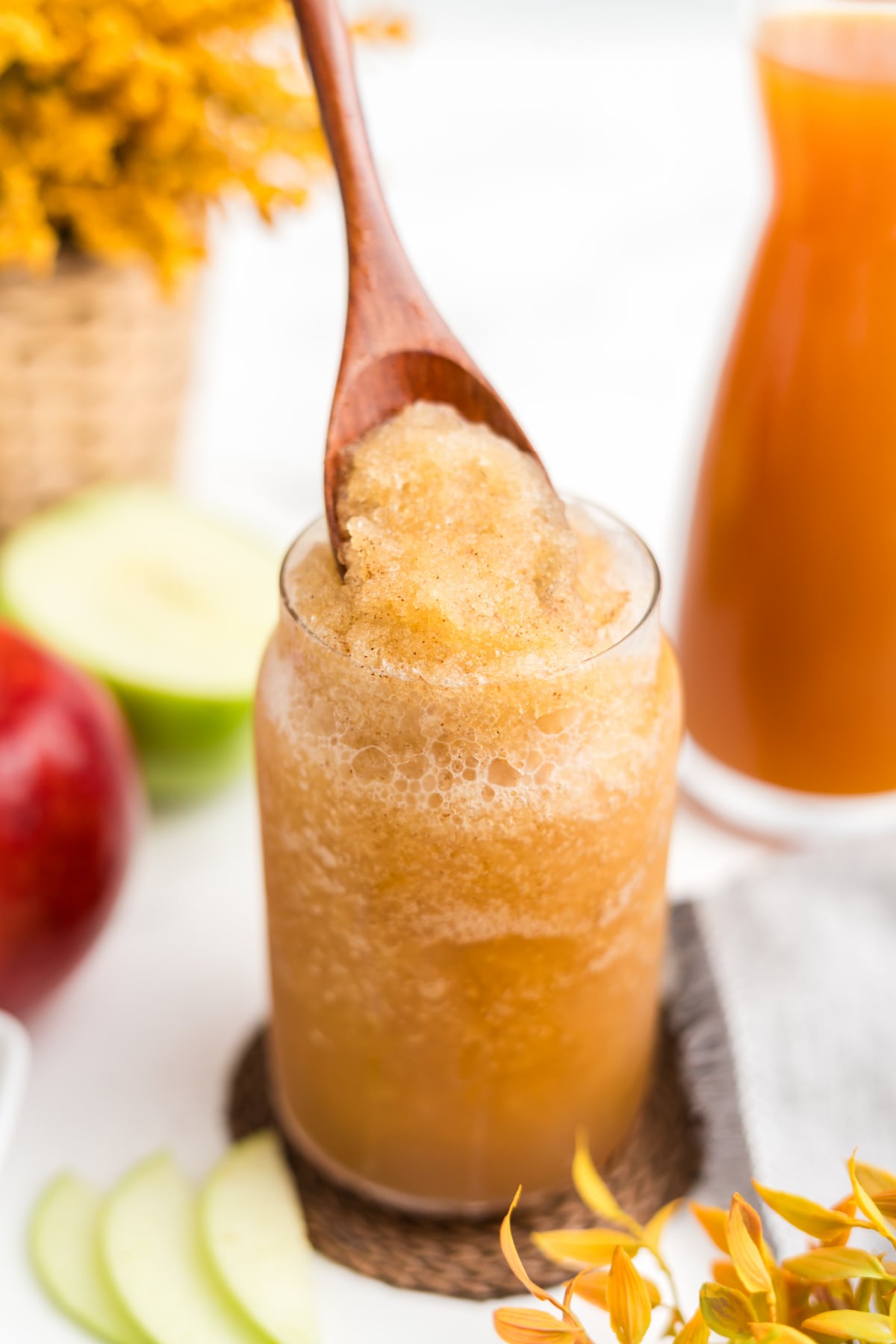 Wooden spoon showing the thick, icy texture of a slushie.