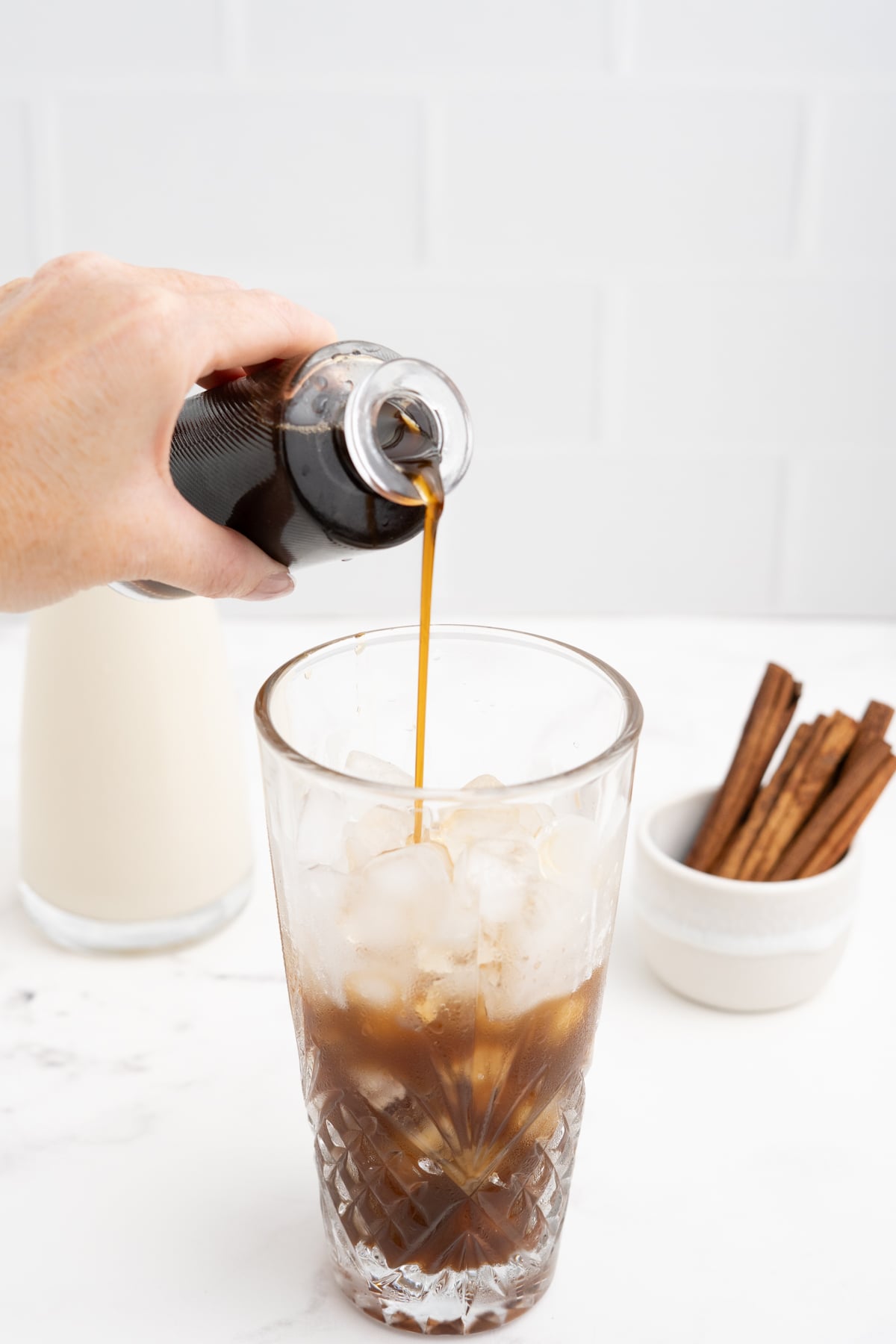 Apple brown sugar syrup is added to ice filled glass.