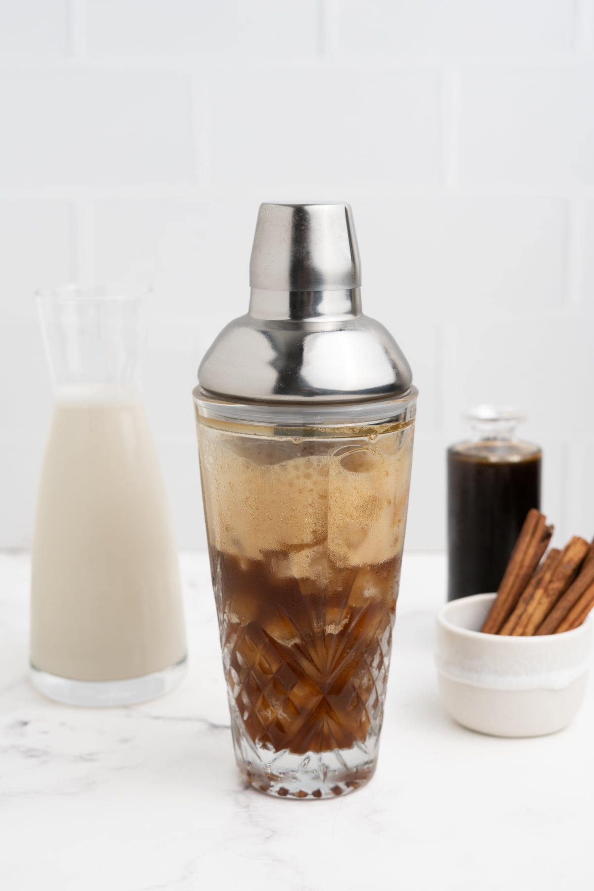 Espresso ingredients are shaken in cocktail shaker.